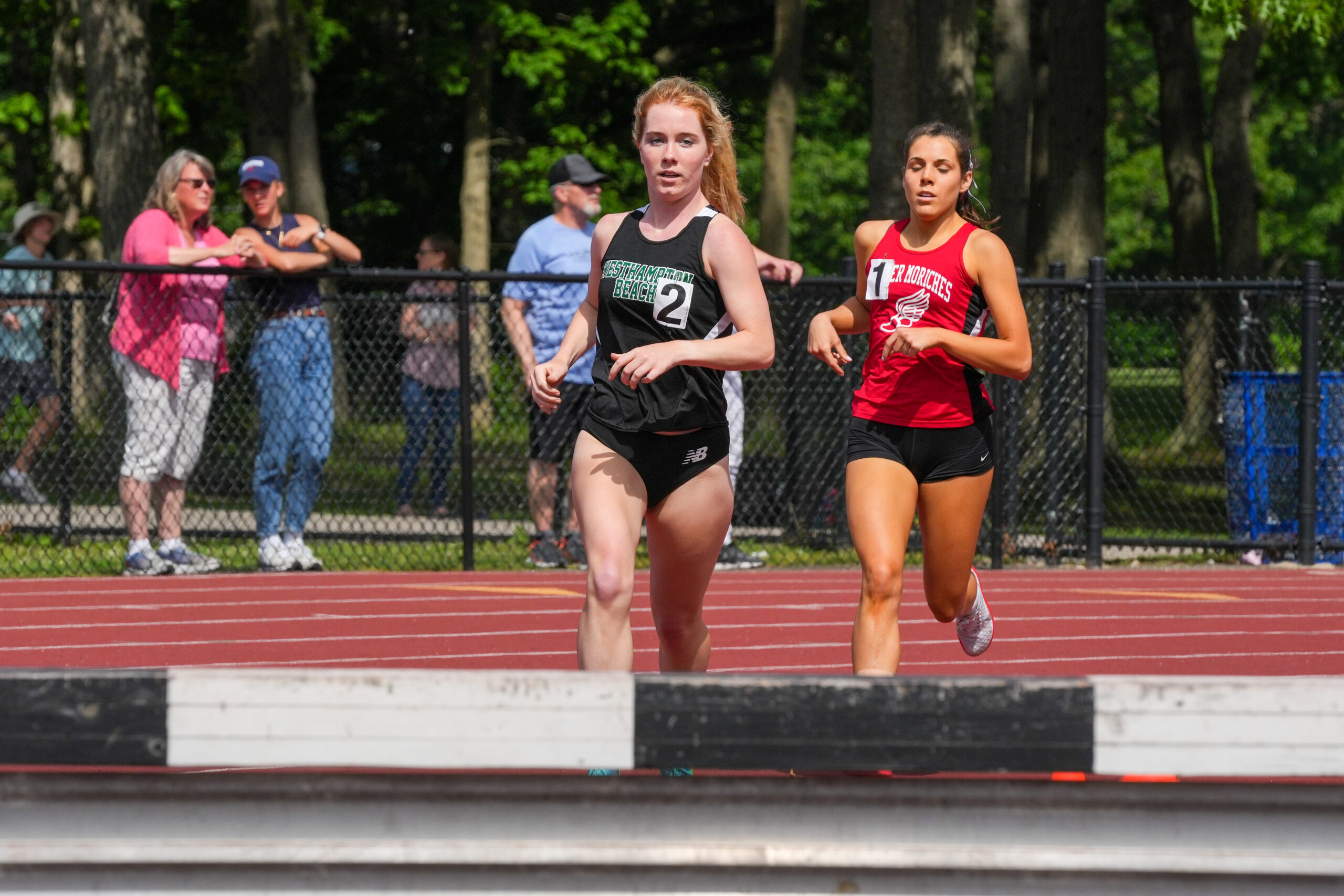 Senior Keira Falvey competes in the 1,000-meter steeplechase at the state qualifiers.  RON ESPOSITO