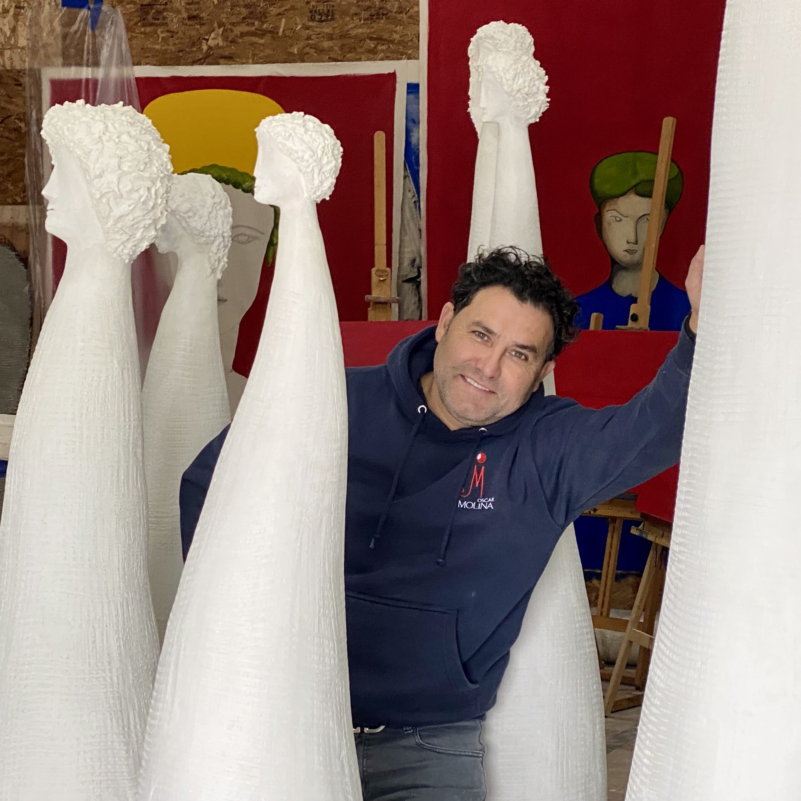 Artist Oscar Molina with some of his sculptural pieces. COURTESY THE ARTIST