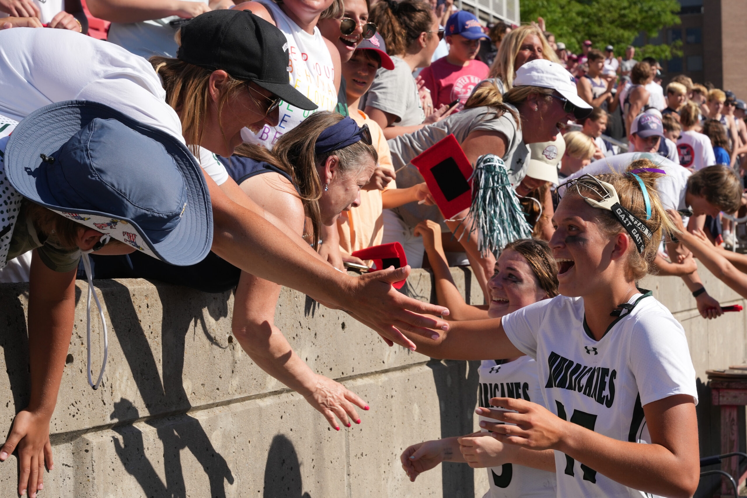 Parents celebrate Westhampton Beach's first-ever Long Island championship win with their daughters, Reese King and Maya Farnan. RON ESPOSITO