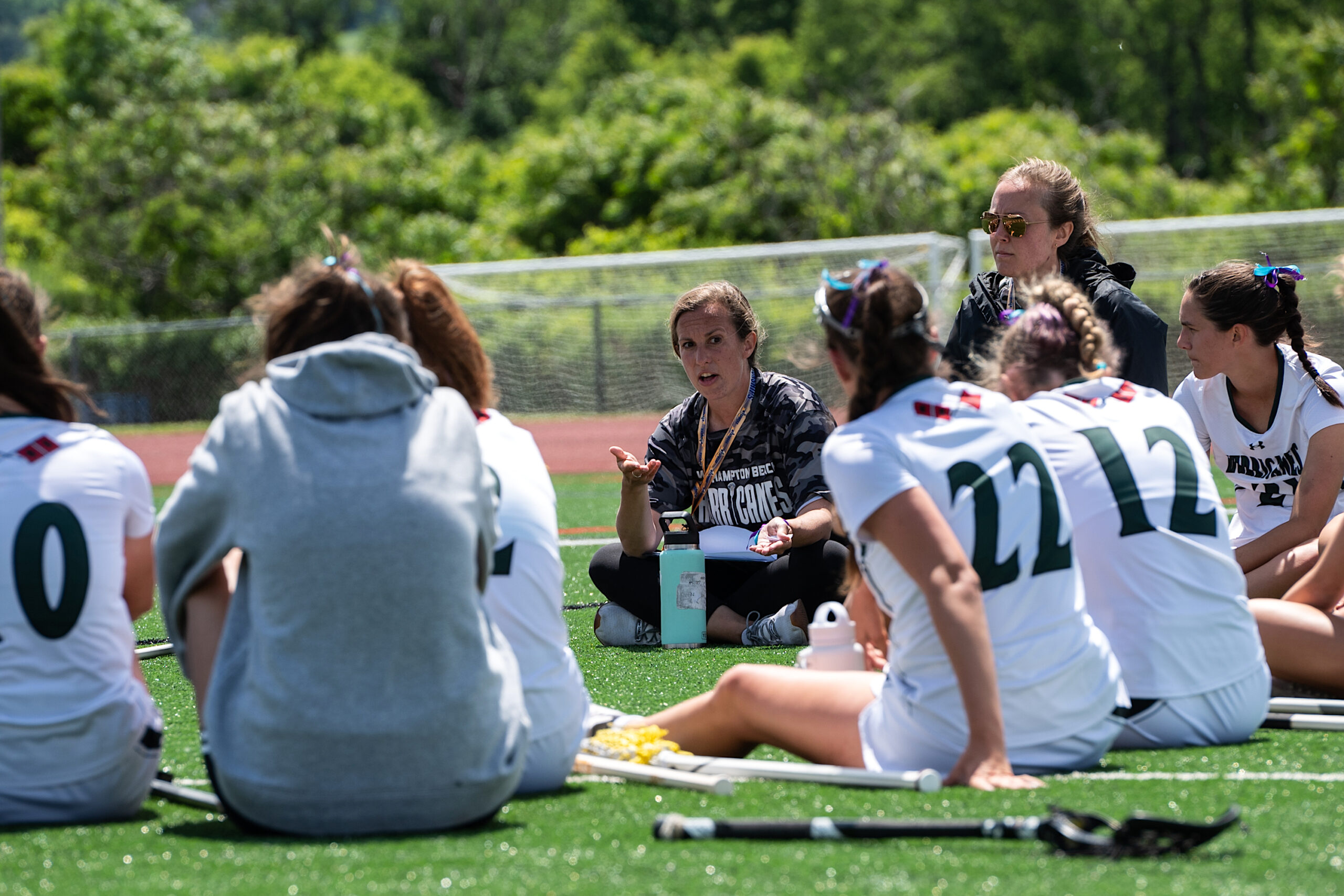 Westhampton Beach head coach Mary Bergmann talks to the members of her girls lacrosse team during halftime. TODD MICHALEK