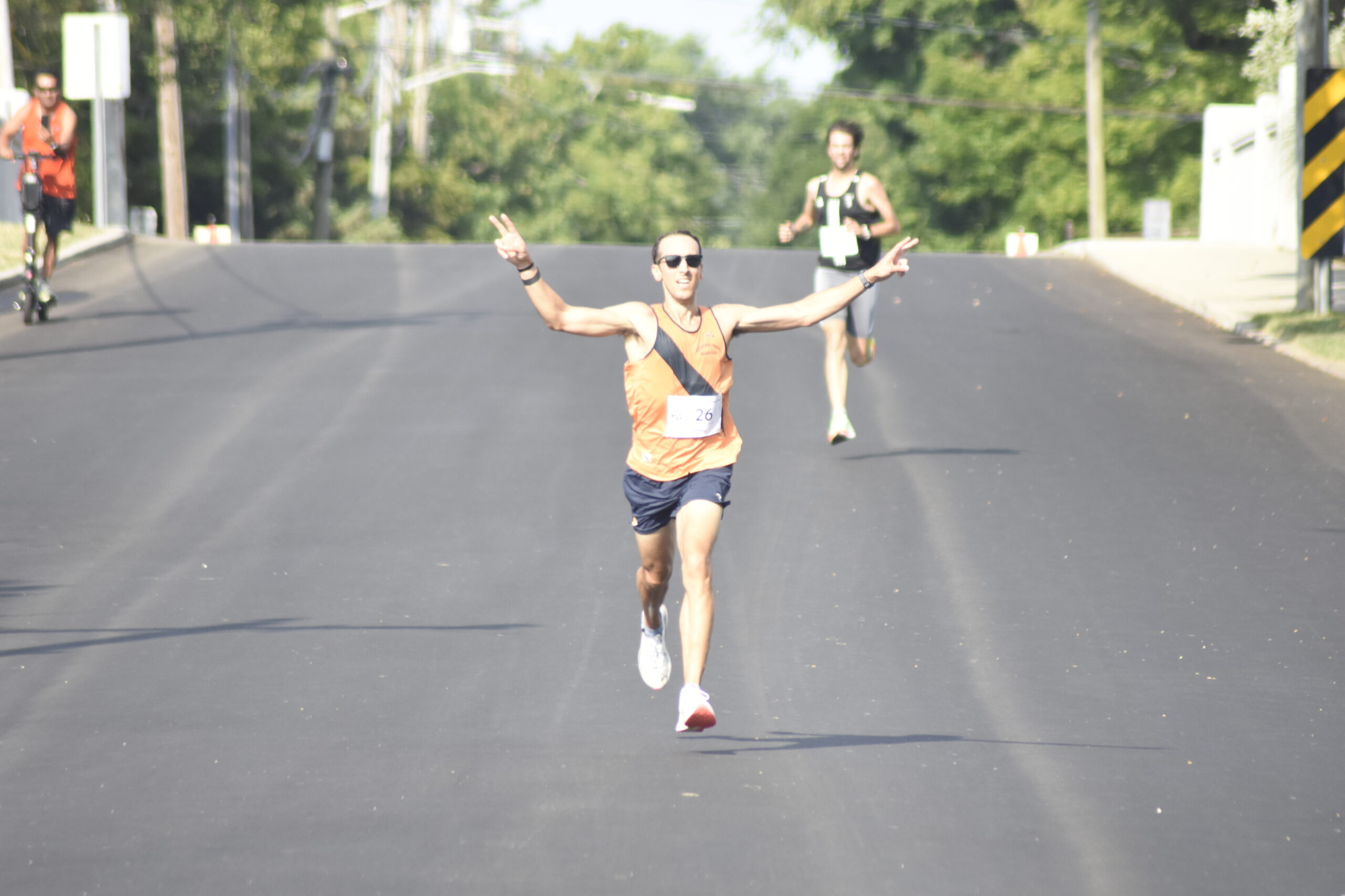 Jeffrey Ares celebrates his victory in the Joe Koziarz Memorial 5K.   DREW BUDD