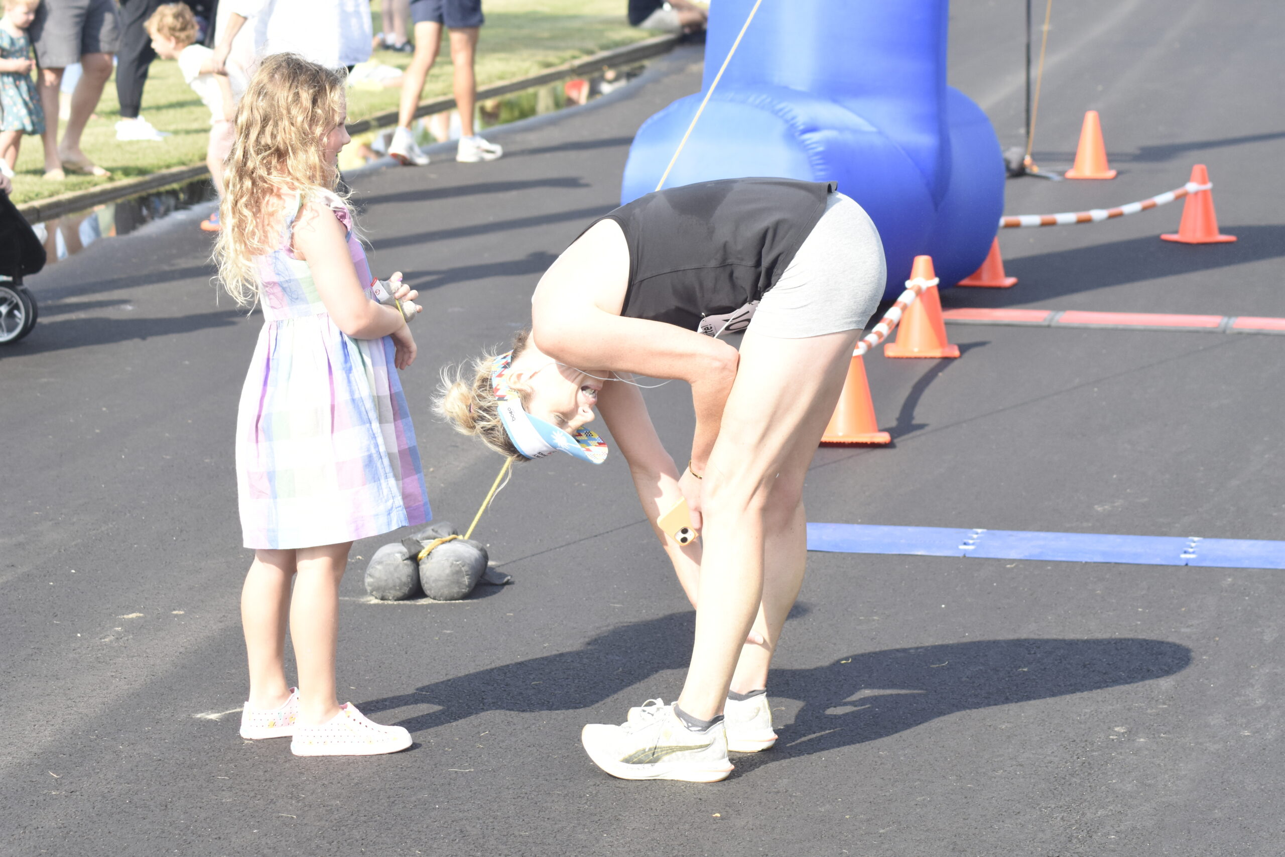 Kimberly Donahue is greeted by her daughter at the finish line.    DREW BUDD