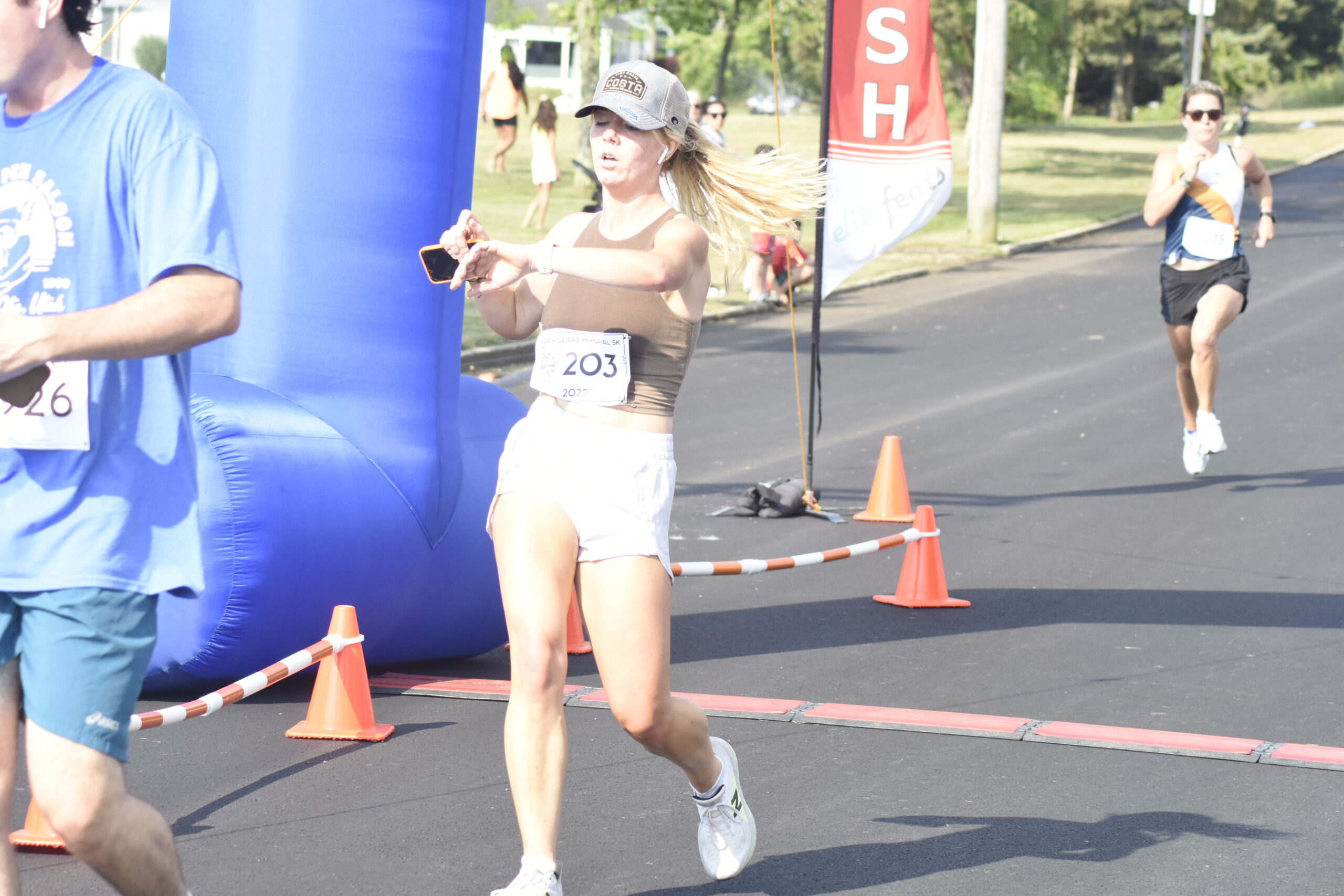 Keira Falvey of Westhampton Beach crosses the finish line.   DREW BUDD