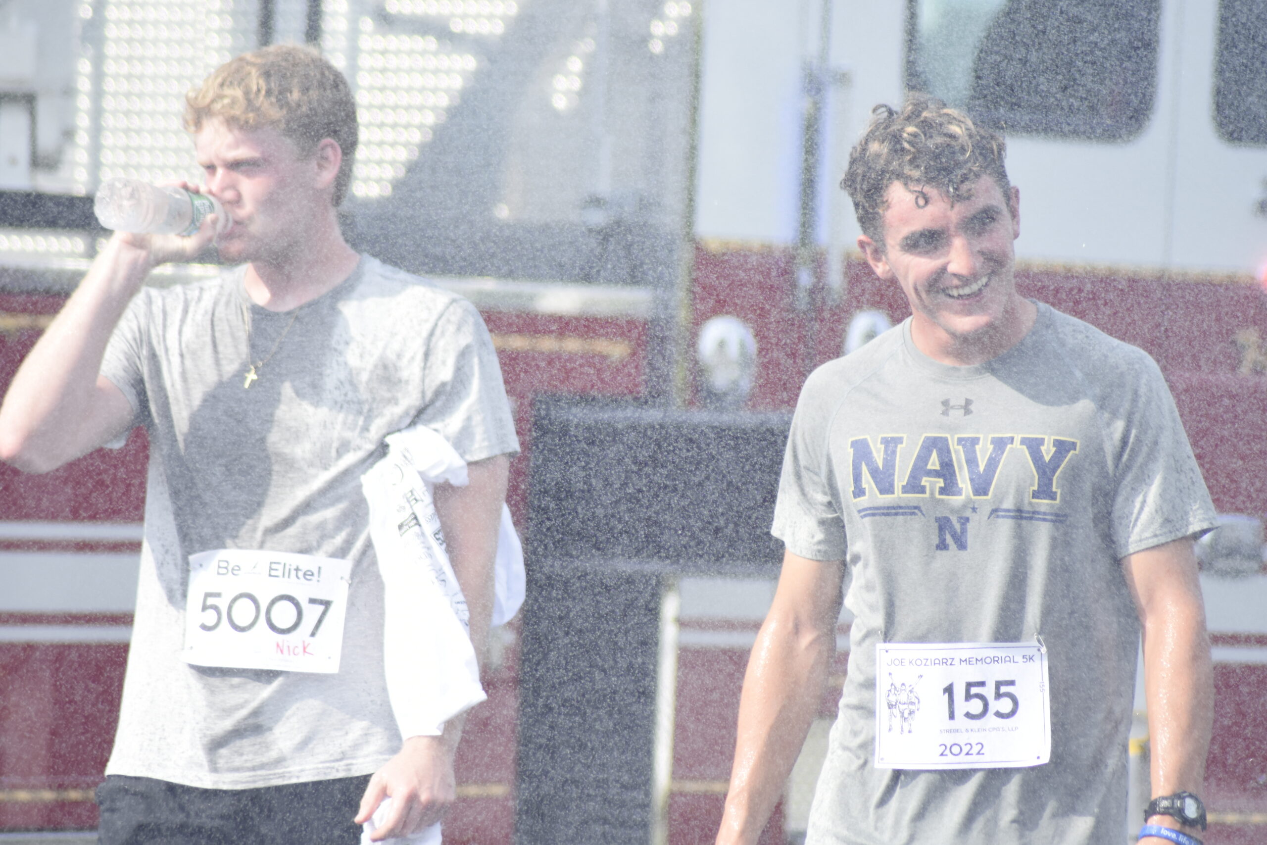 Nick Waszkelewicz, left, and Liam McMunn enjoy a post-race shower.   DREW BUDD