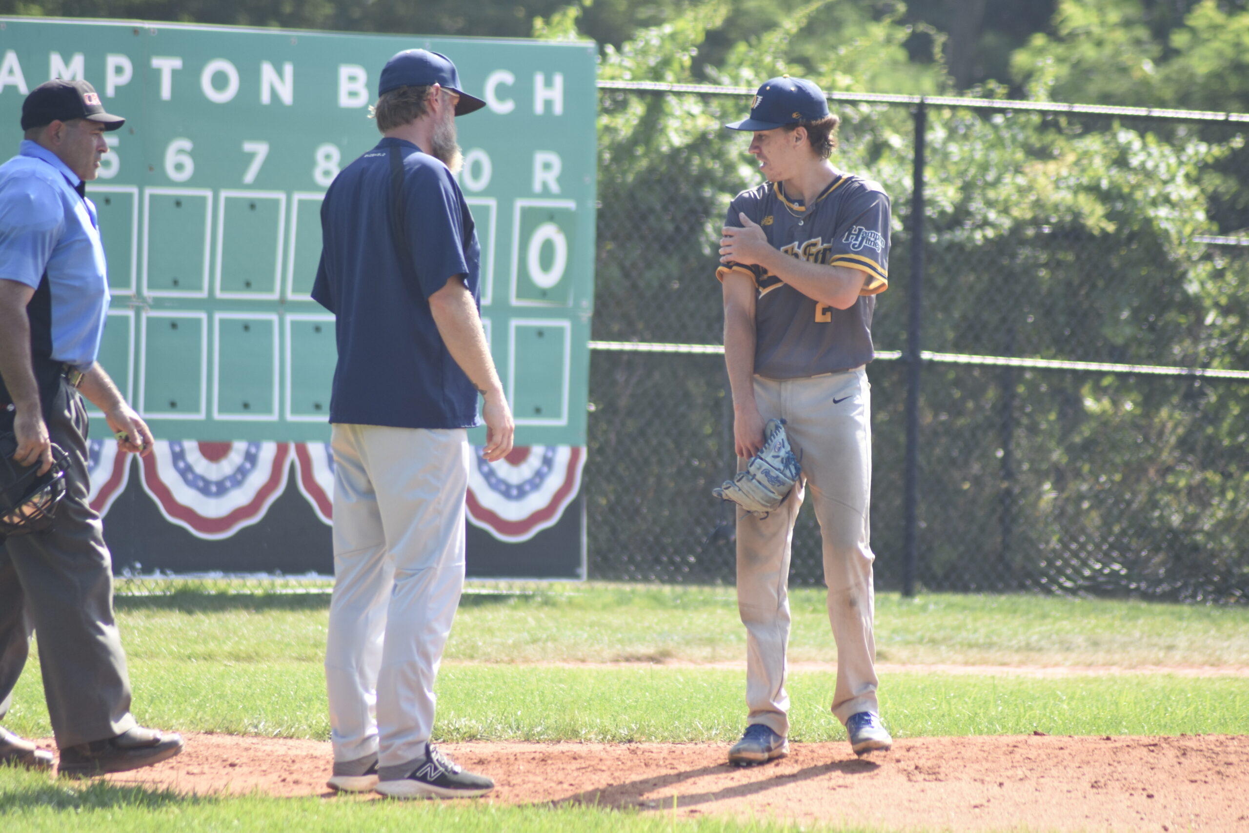 North Fork Ospreys manager Jeramiah Arneson checks out his starting pitcher Jake Halloran (Hofstra) after taking a line drive off his pitching arm.  Halloran stayed in the game and wound up throwing the first four innings.    DREW BUDD