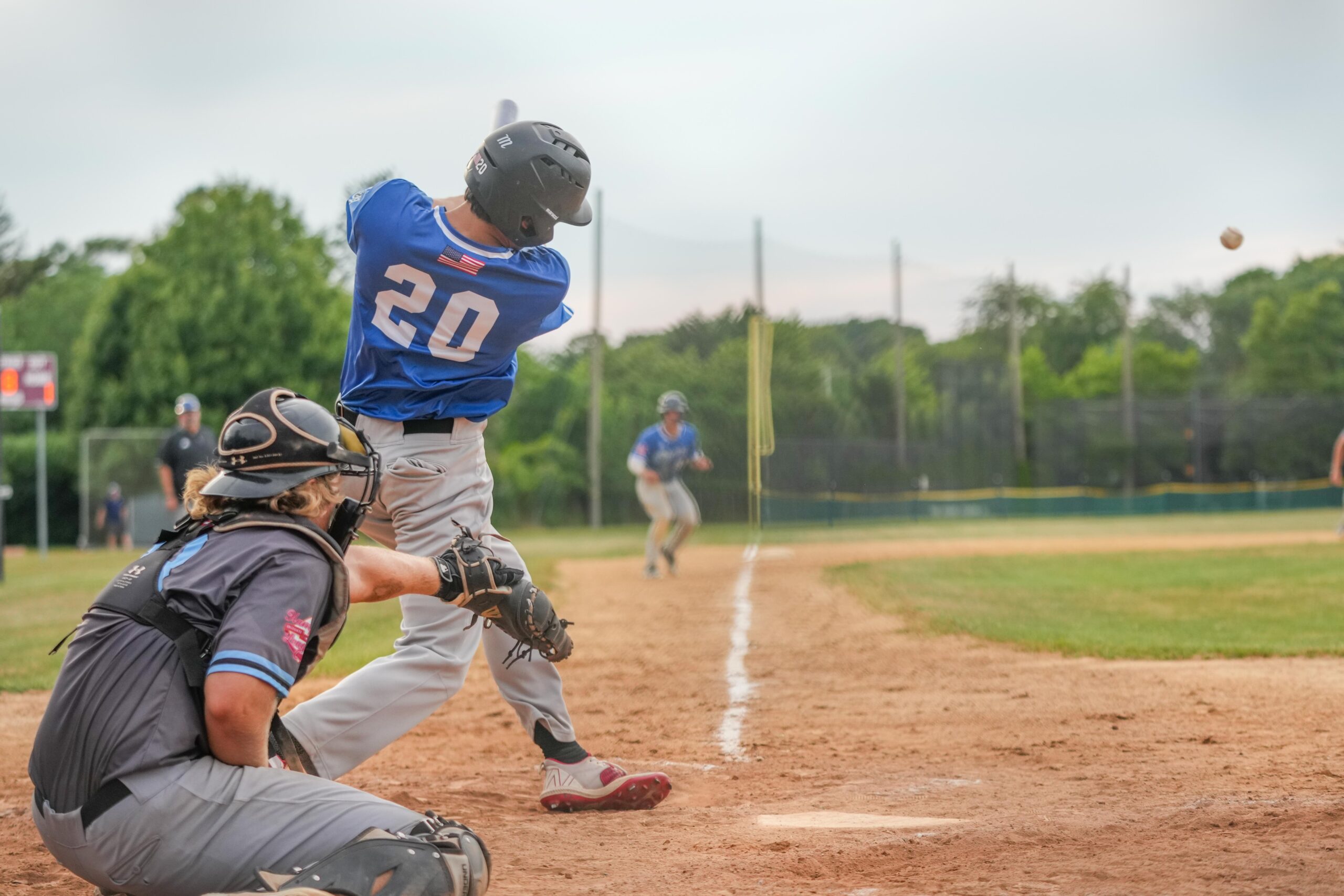 Southampton's Nathan Brasher (Brown) sends a single into the outfield that drives in a pair of runs making it a 7-6 game in the bottom of the ninth.    RON ESPOSITO