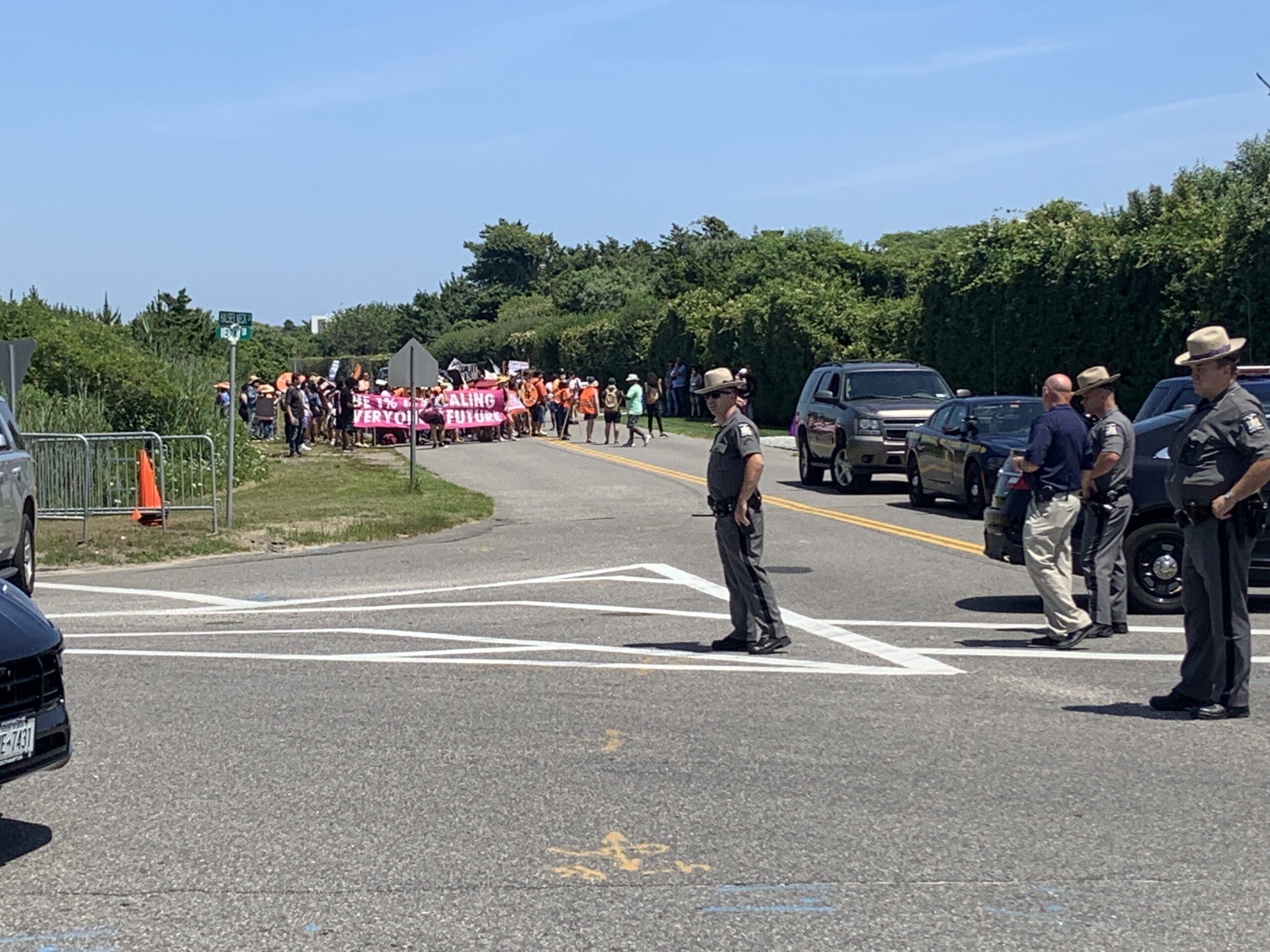 Police blocked traffic as protesters calling for higher taxes on billionaires to help cover the costs of everything from childcare to climate change mitigation, marched on Meadow Lane in Southampton Village on Saturday.  STEPHEN J. KOTZ