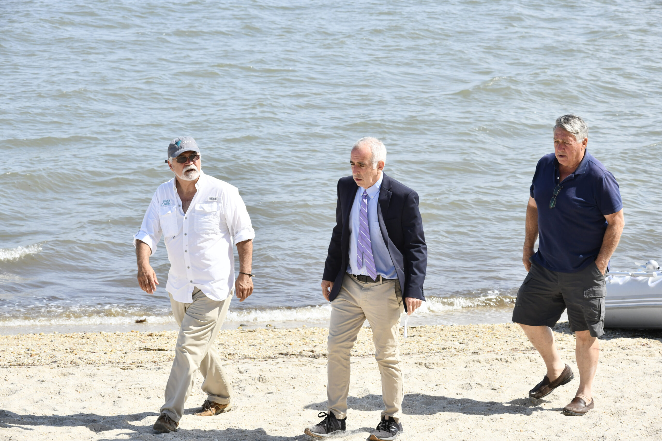 Aram Terchunian, Supervisor Jay Schneiderman and Mark Matthews of Conscience Point Shellfish at North Sea Beach on July 6.  DANA SHAW