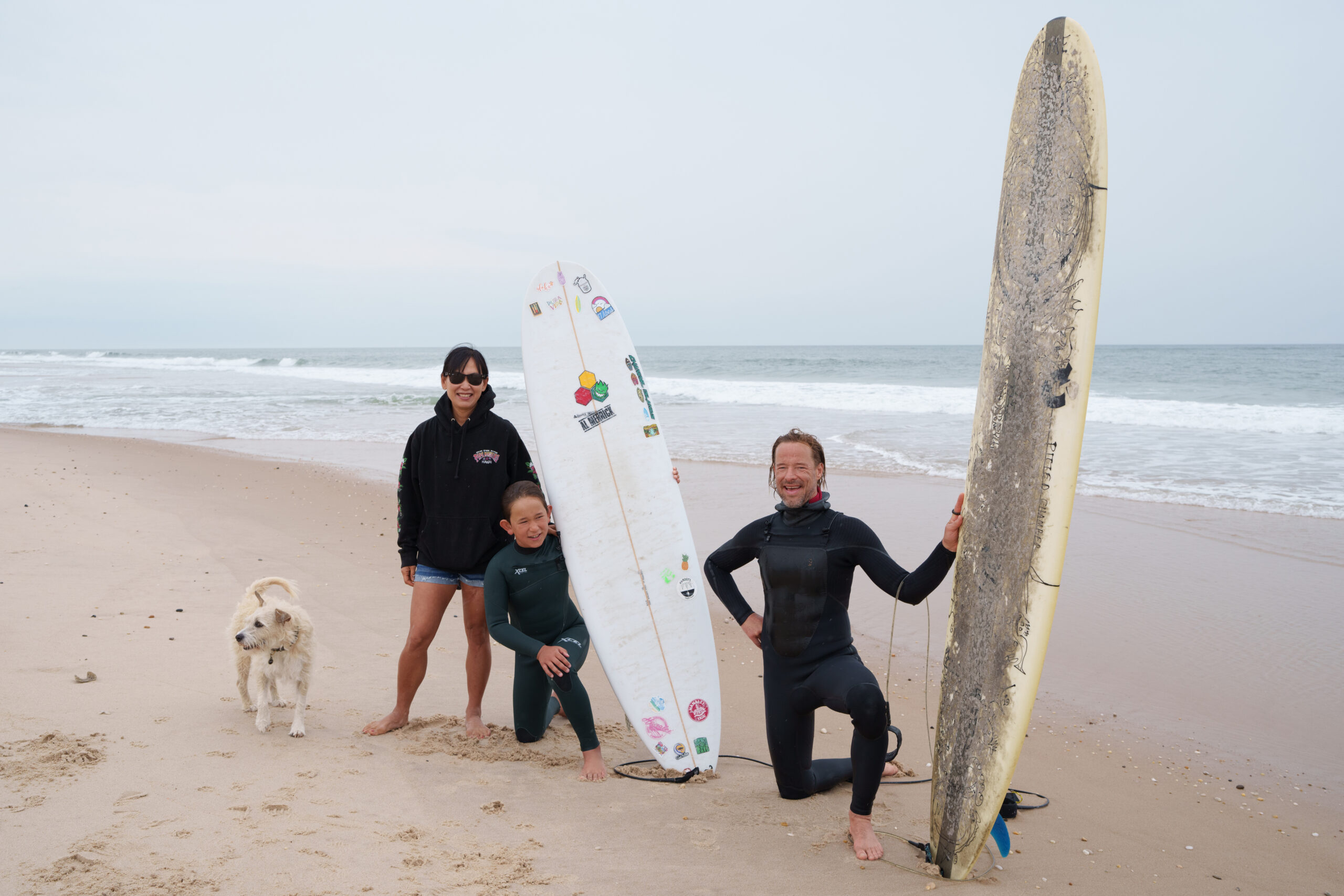 Quentin Curry with his son, Mason, and wife, Shelley Suh after as surf session.
