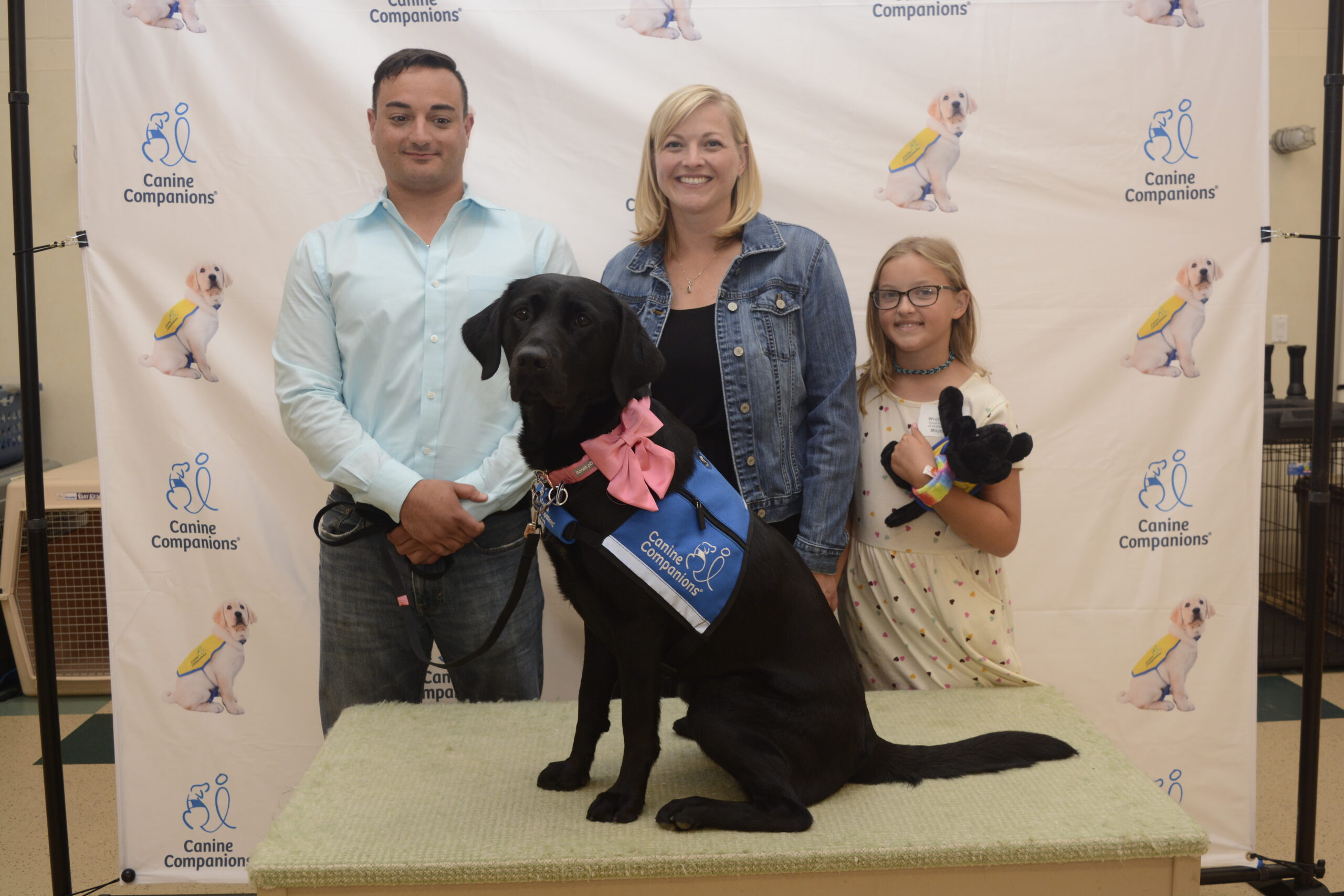 From left, special education teacher Michael Morlino, Hampton Bays resident Kate Fullam and her daughter, Wren Fullam, with Maybie, at her graduation from the Canine Companions training program last week. The Fullams were volunteer 