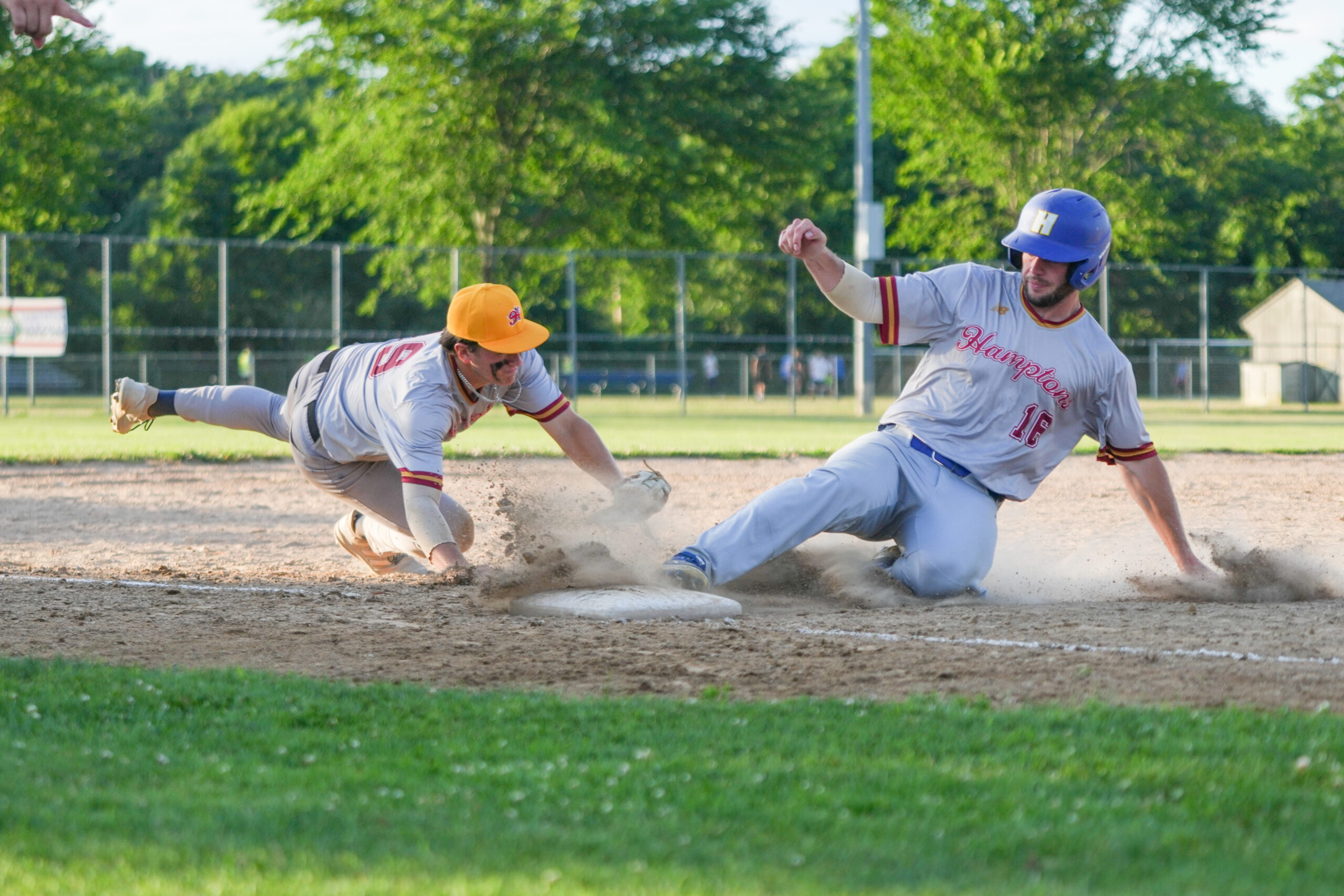 Red Team All-Star Sean Flaherty (Southampton/Hofstra) slides in safely at third base ahead of Gold Team All-Star Matt Shuhet's tag.   RON ESPOSITO