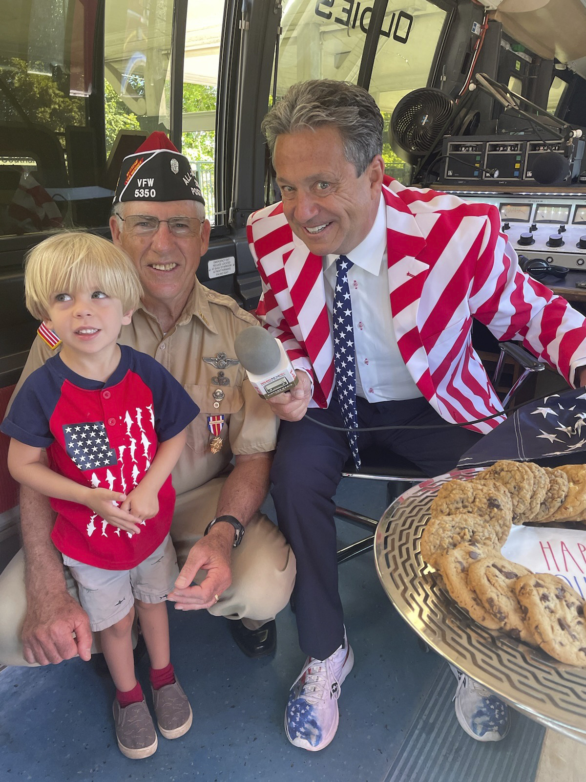 Jameson Hughes, William Hughes VFW Post 5350 Commander and Mr. Bill Evans Owner and host at WLNG, broadcasting from the Southampton July 4 parade.    COURTESY WILLIAM HUGHES
--