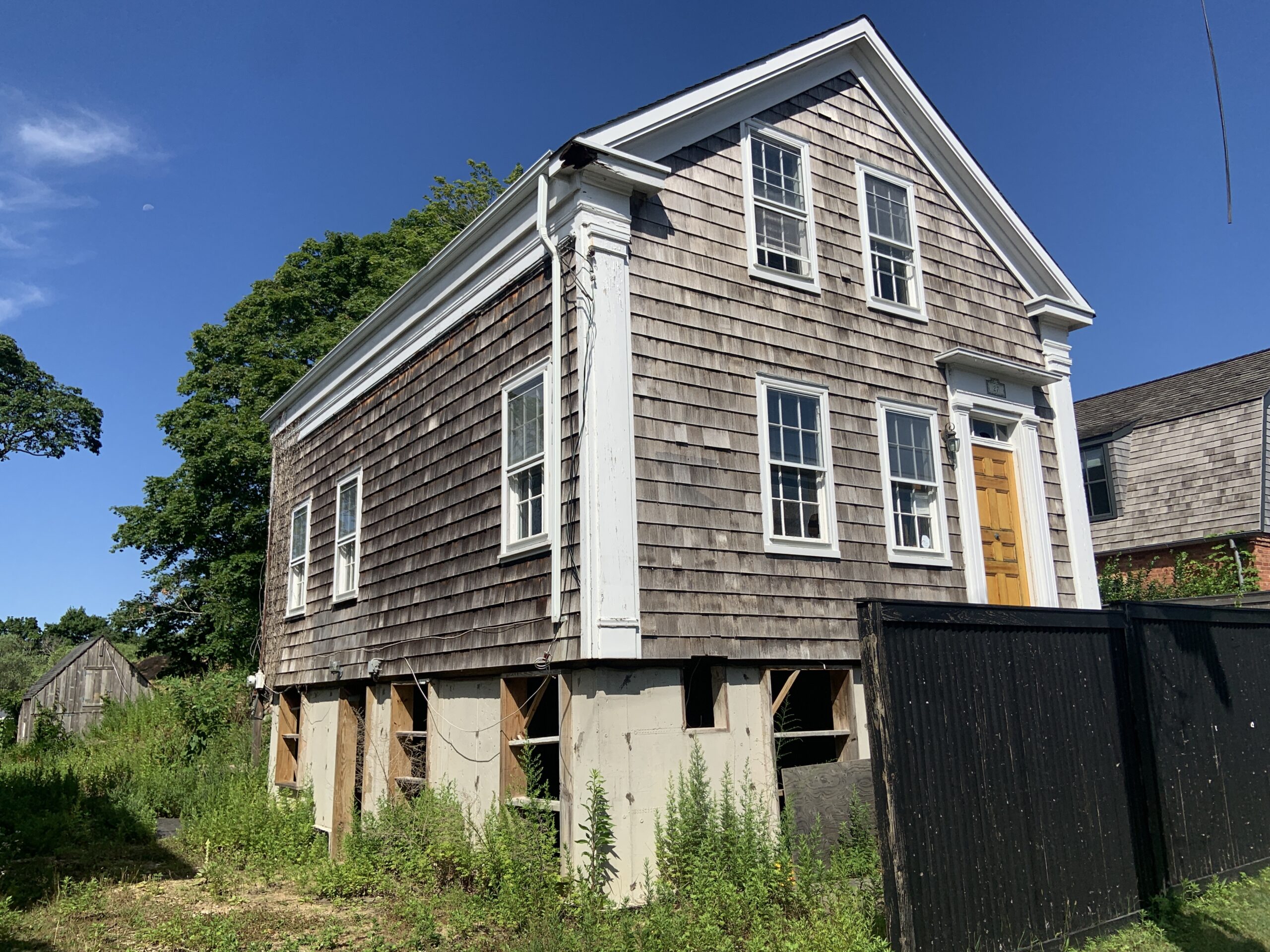 Although a new foundation was completed about three years ago, work on this house at 27 Howard Street has been stalled while a lawsuit over its ownership winds its way through the courts. STEPHEN J. KOTZ