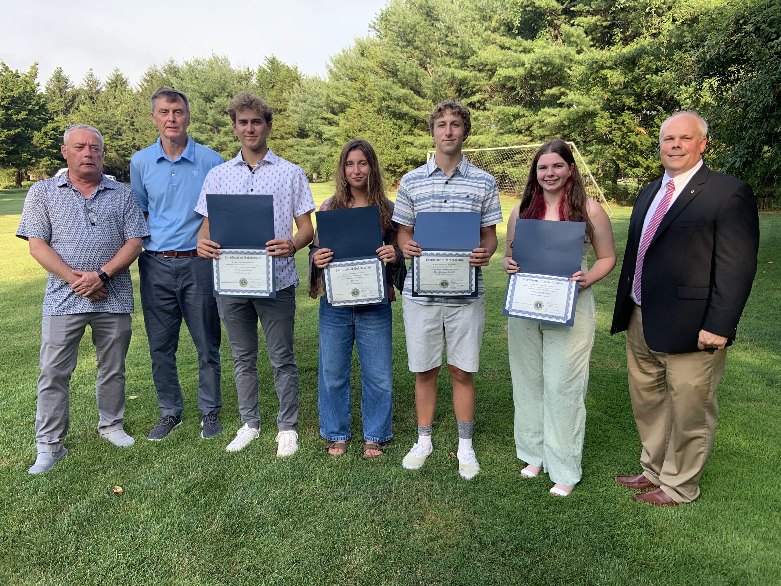 The Sag Harbor Lions Club recently presented scholarships totaling $41,500 to four Pierson High School graduates. From left, Tony Lawless and Paul Zaykowski, Lions Club co-presidents, Reed Kelsey, Eve Iulo, Troy Remkus, Emily Glass, and Lions Club selection committee member Mark Poitras. STEPHEN J. KOTZ