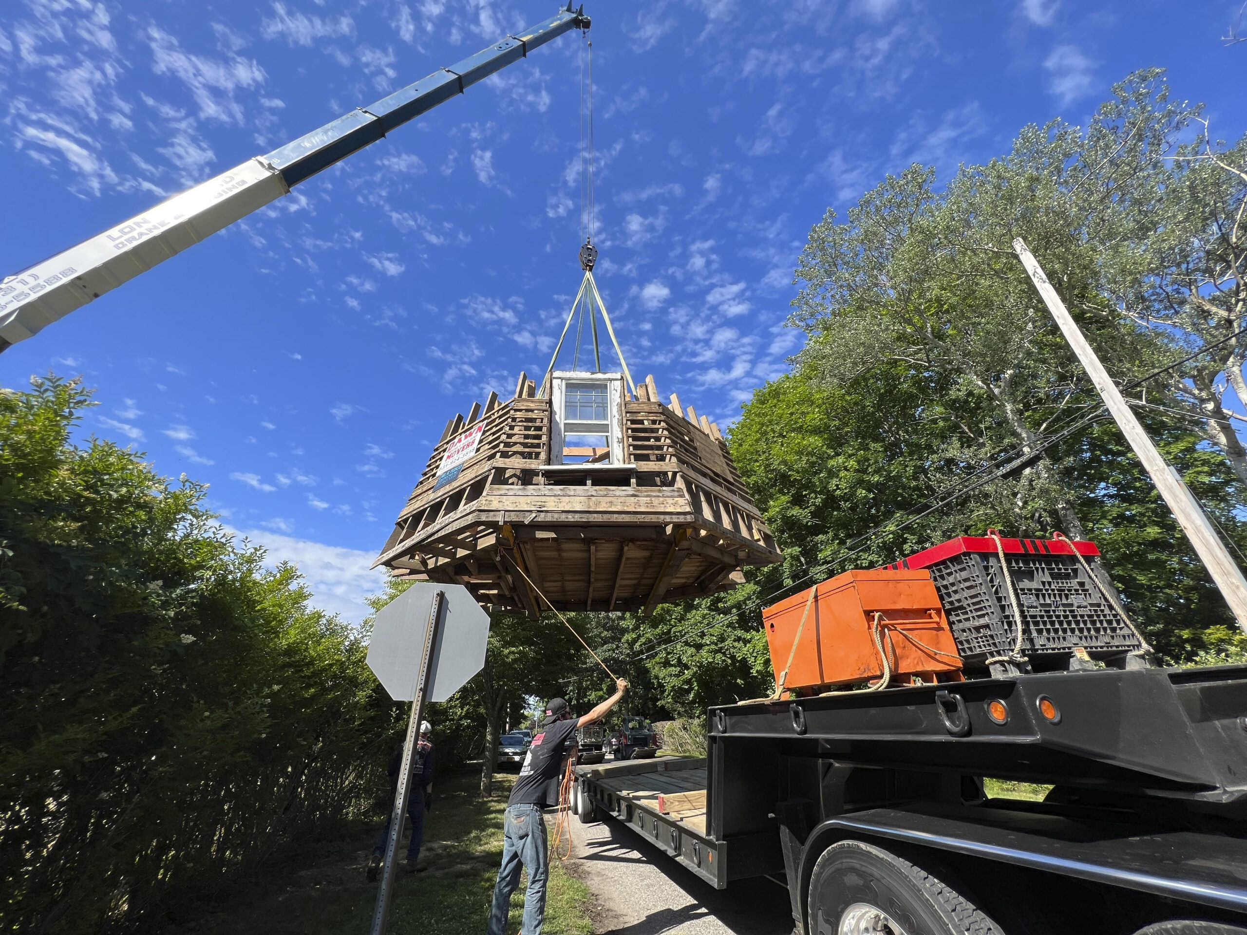 The last section of the windmill is lowered onto the truck for transport.  DANA SHAW