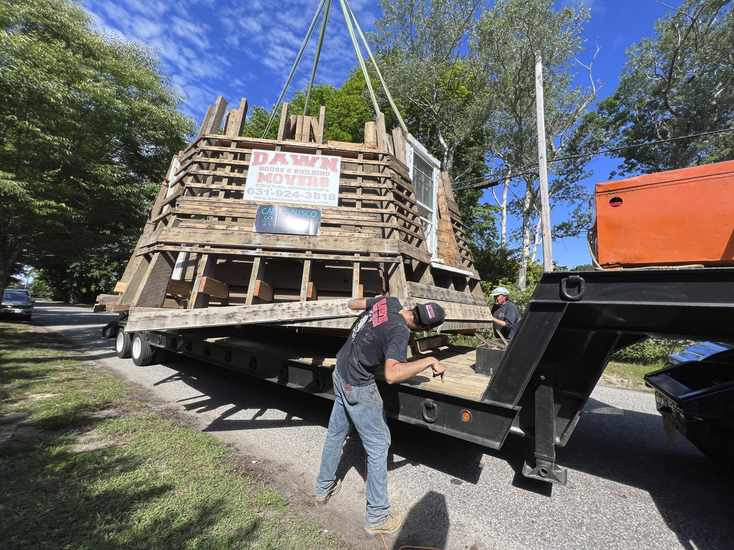 The last section of the windmill is lowered onto the truck for transport.  DANA SHAW