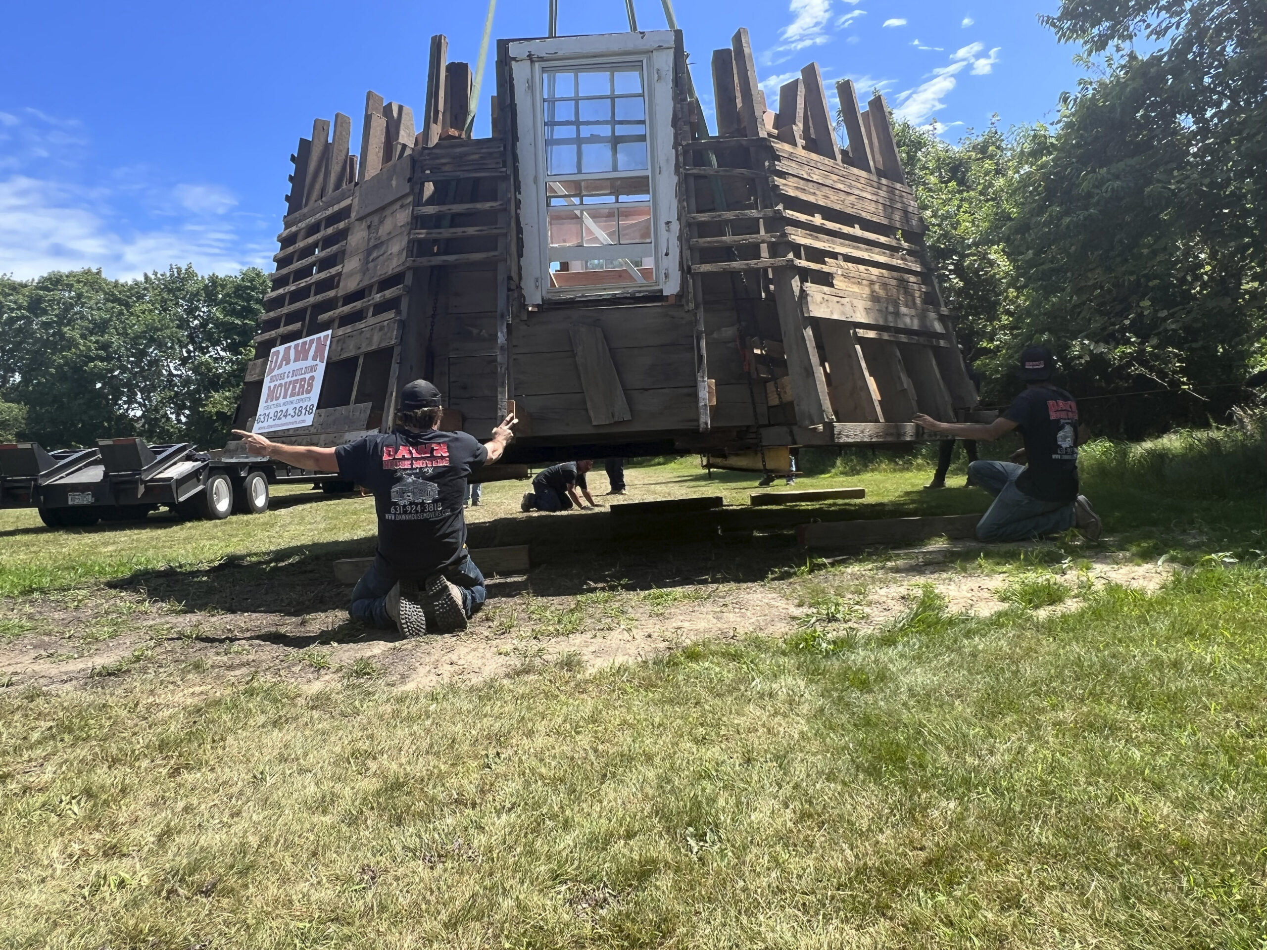 The first section of the windmill is lowered onto the Great Lawn.   DANA SHAW