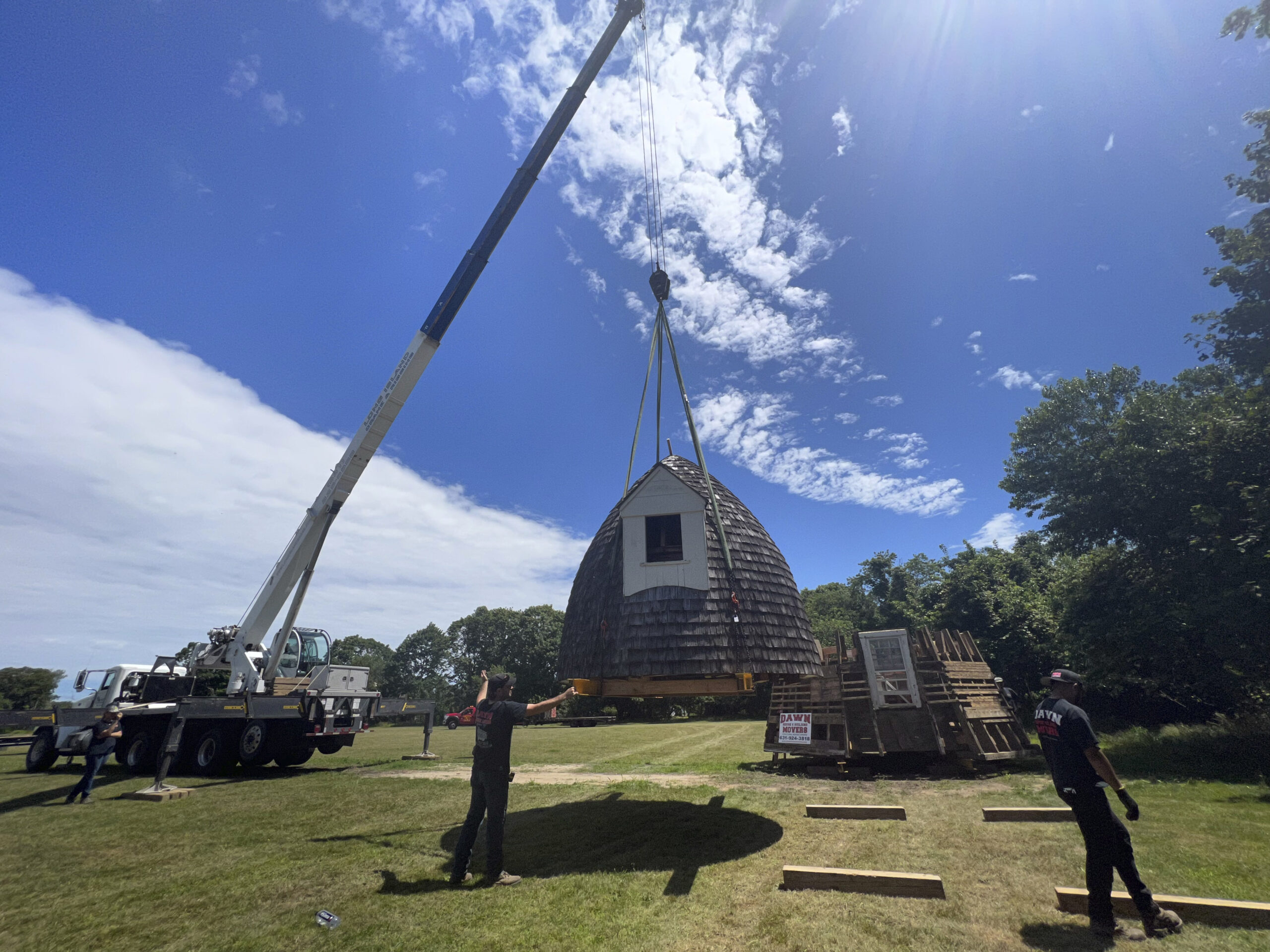 The cap of the windmill is lowered onto the Great Lawn.  DANA SHAW