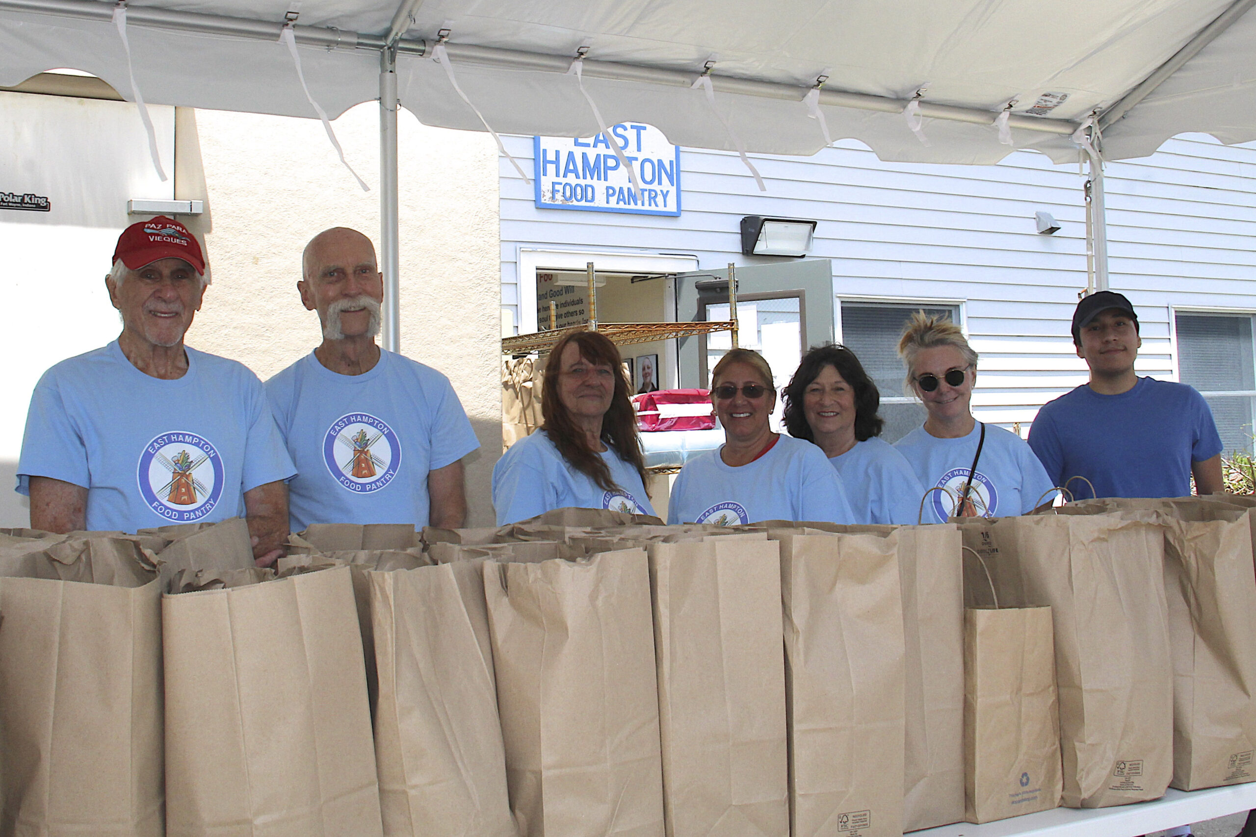 Volunteers Philip Freedman, Frank Rehor, Mona Forbell, Vicki Littman, Valerie Bando-Meinken, Bonnie Rychlak and Nick Sigua at the East Hampton Food Pantry.    KYRIL BROMLEY