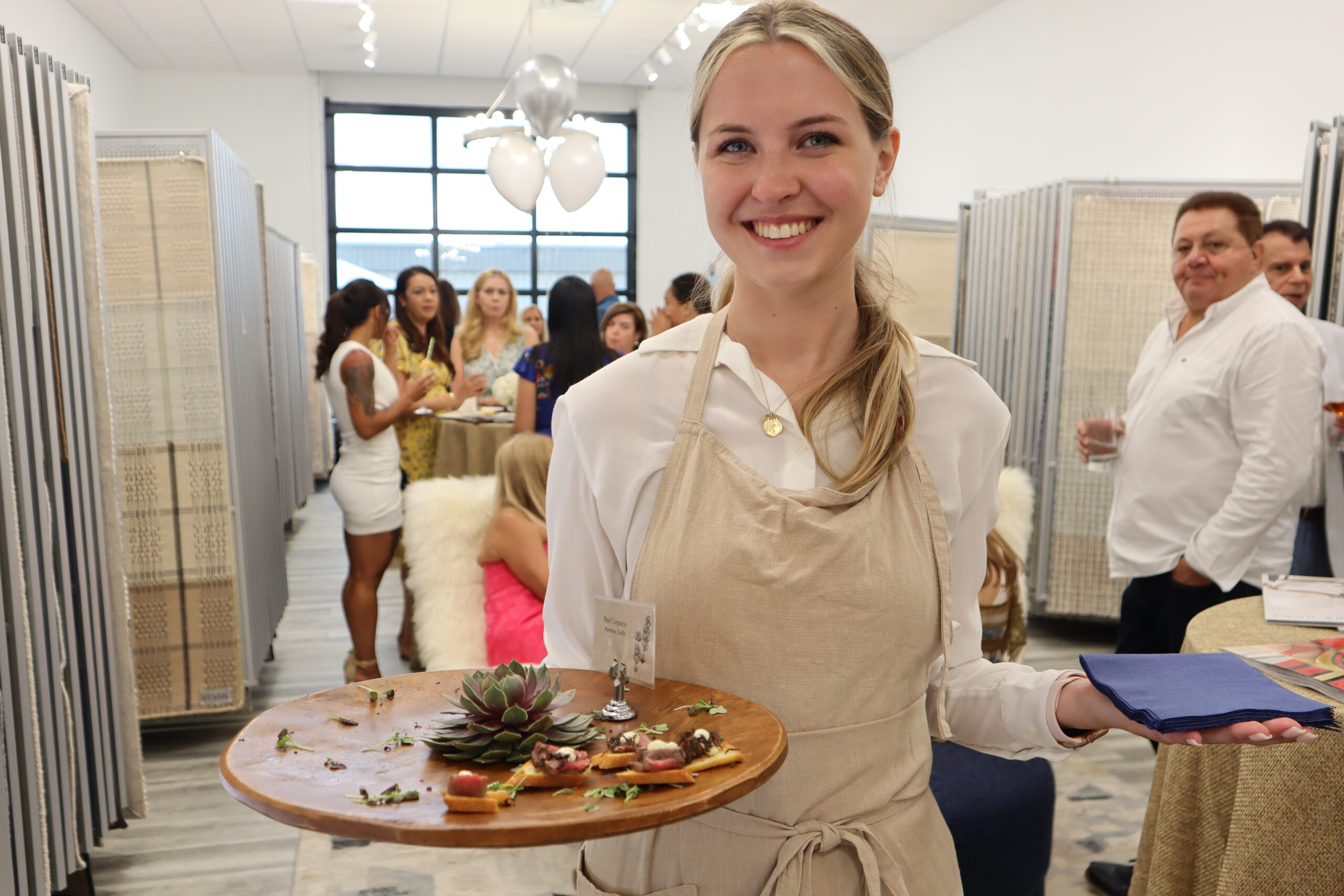 Kristina Mirecki, a server with Stone Creek Catering, serves beef carpaccio with parmesan and truffle.  MEGAN NAFTALI