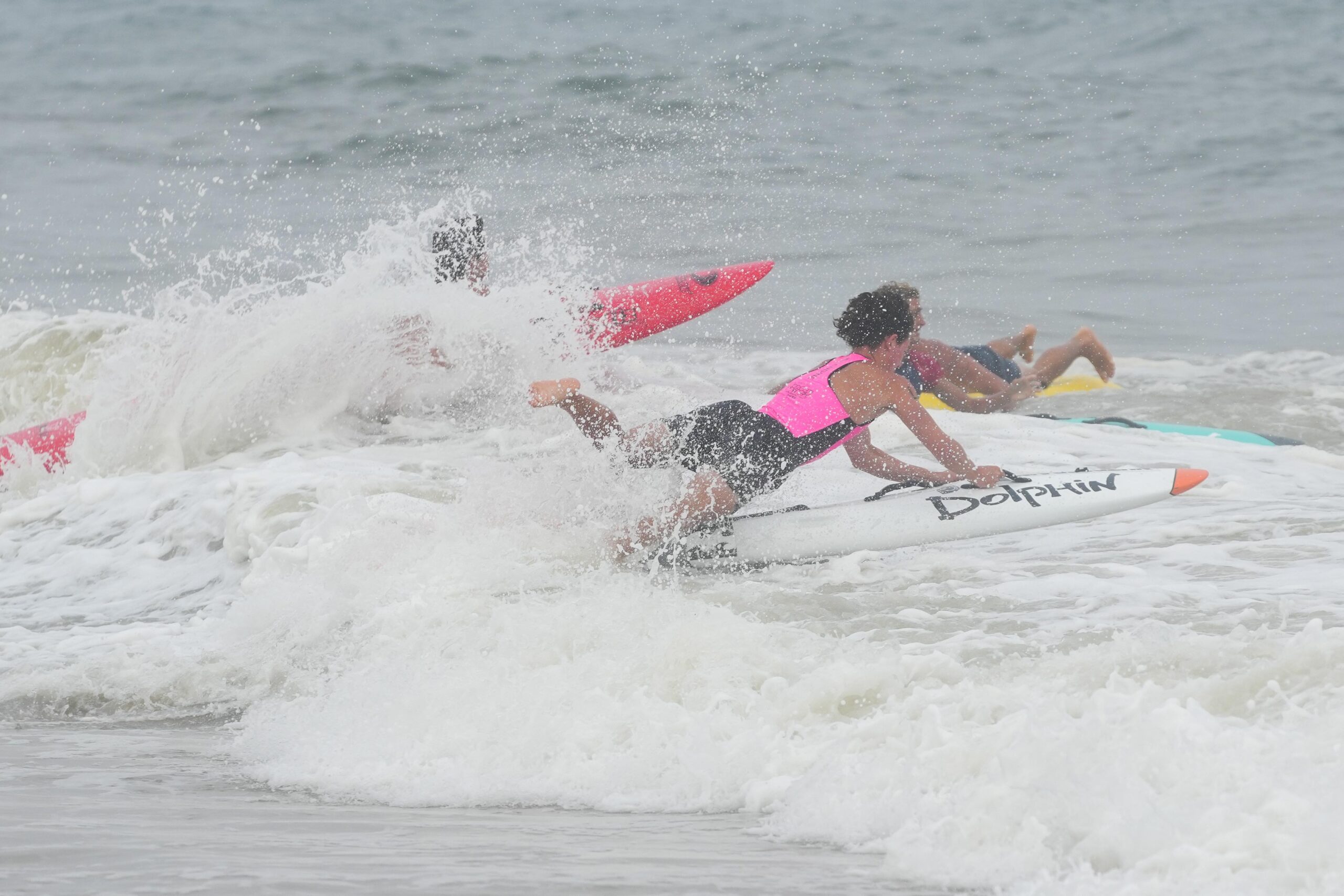 Lifeguards head into the surf during the board rescue race.    RON ESPOSITO