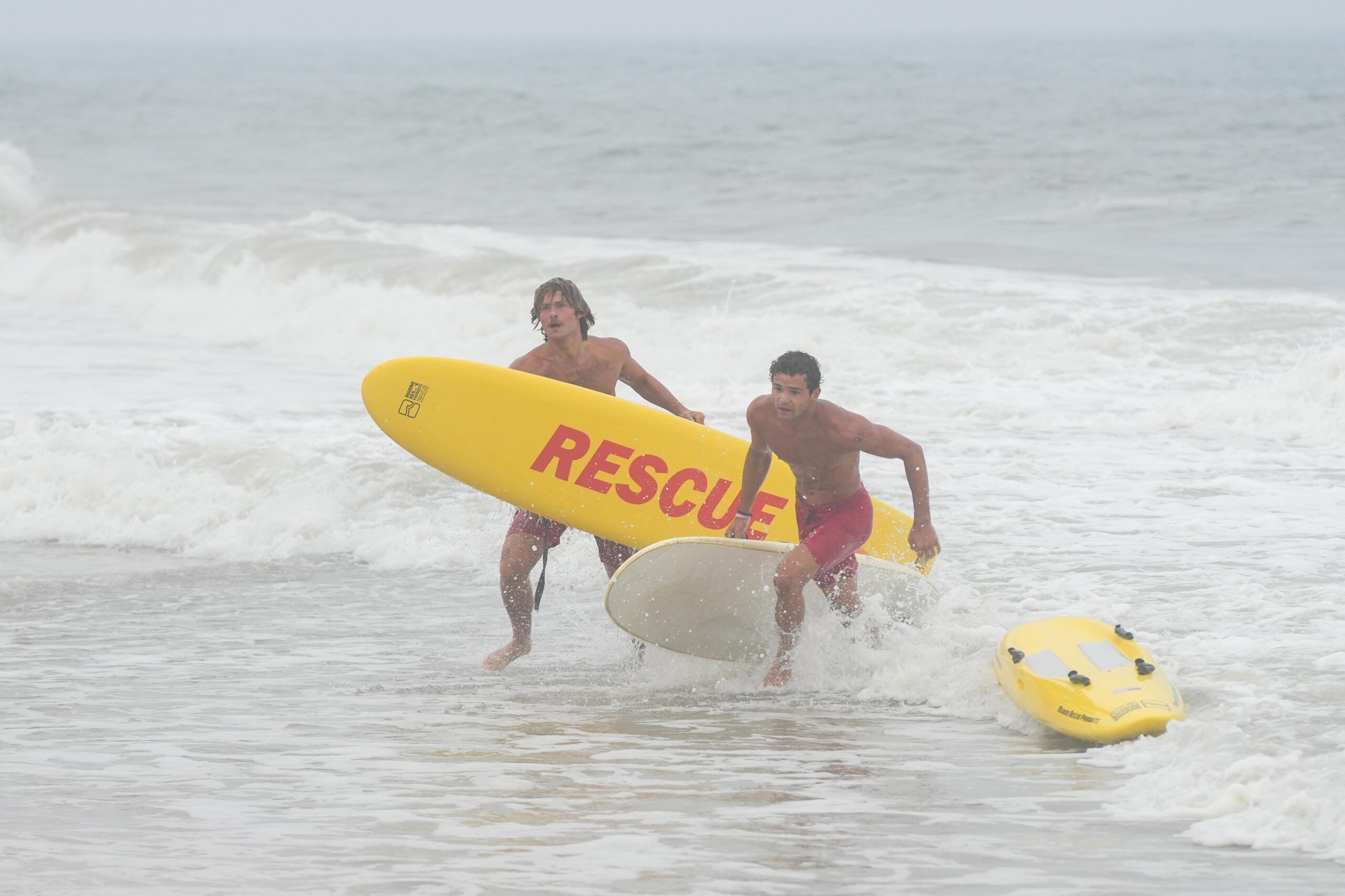 Lifeguards head out of the surf during the board rescue race.    RON ESPOSITO