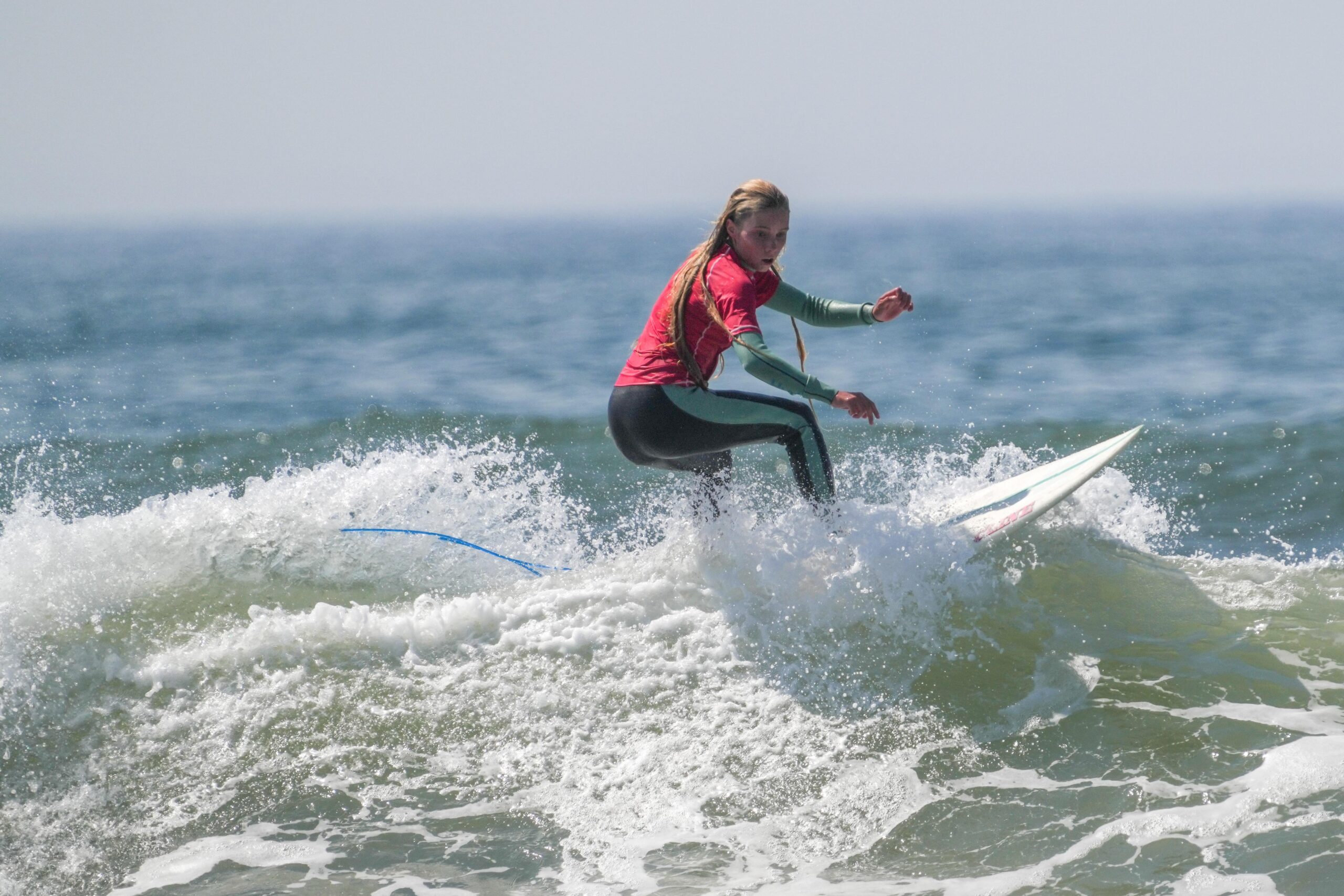 Surfers compete in the 24th annual Rell Sunn Memorial Surf Contest at Ditch Plains on Saturday morning.    RON ESPOSITO