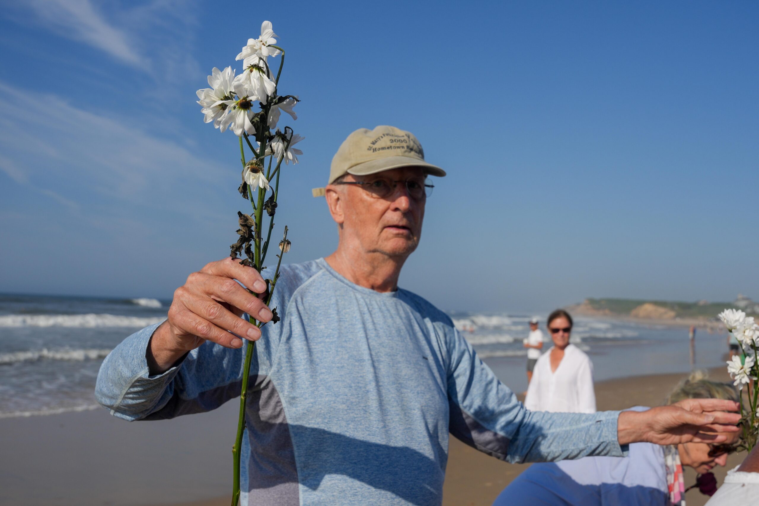 Wackford Breuer hands out flowers for the memorial prior to the 24th annual Rell Sunn Memorial Surf Contest at Ditch Plains on Saturday morning.    RON ESPOSITO