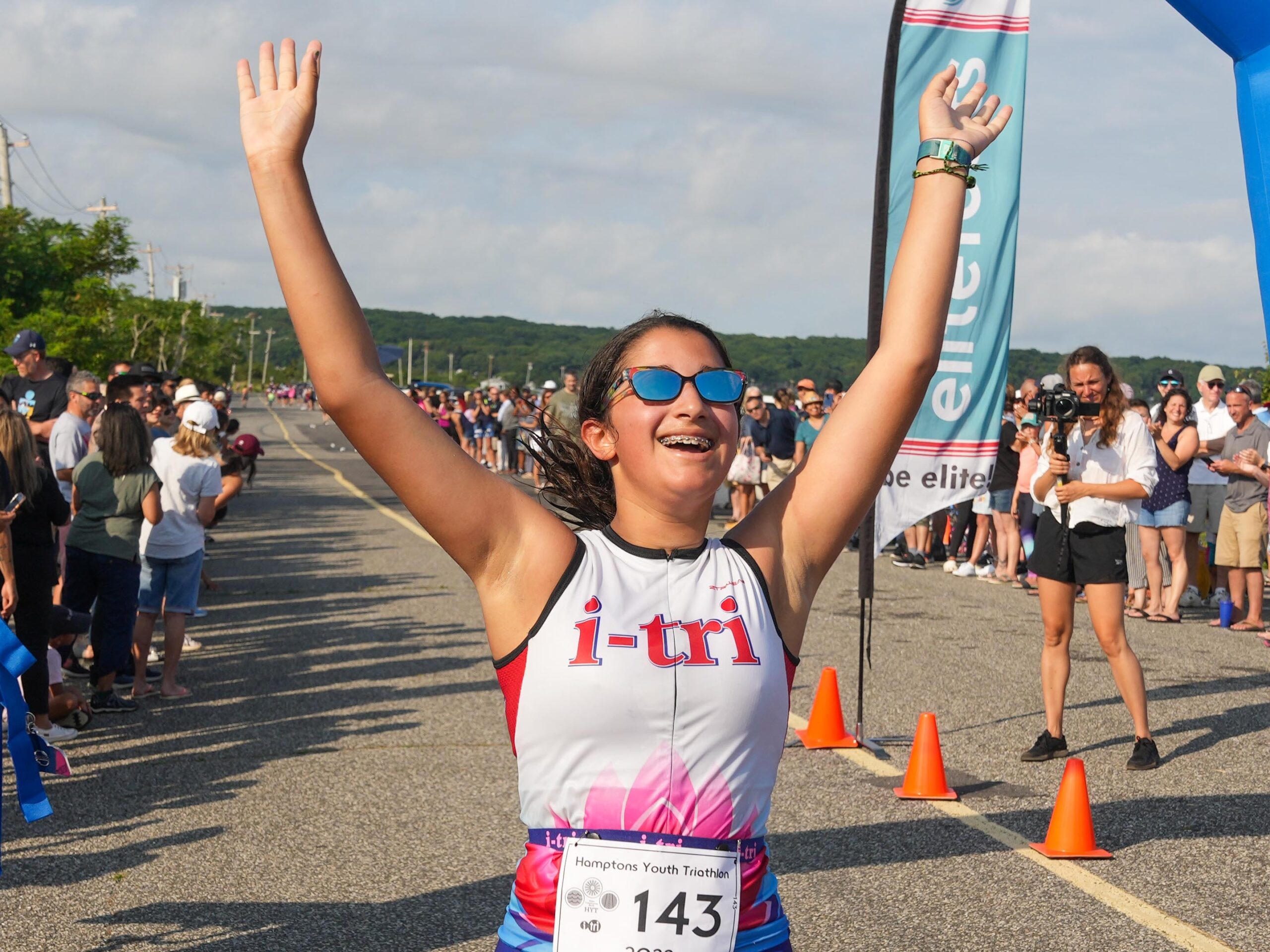 Lily Caplin of Sag Harbor crosses the finish line.   RON ESPOSITO