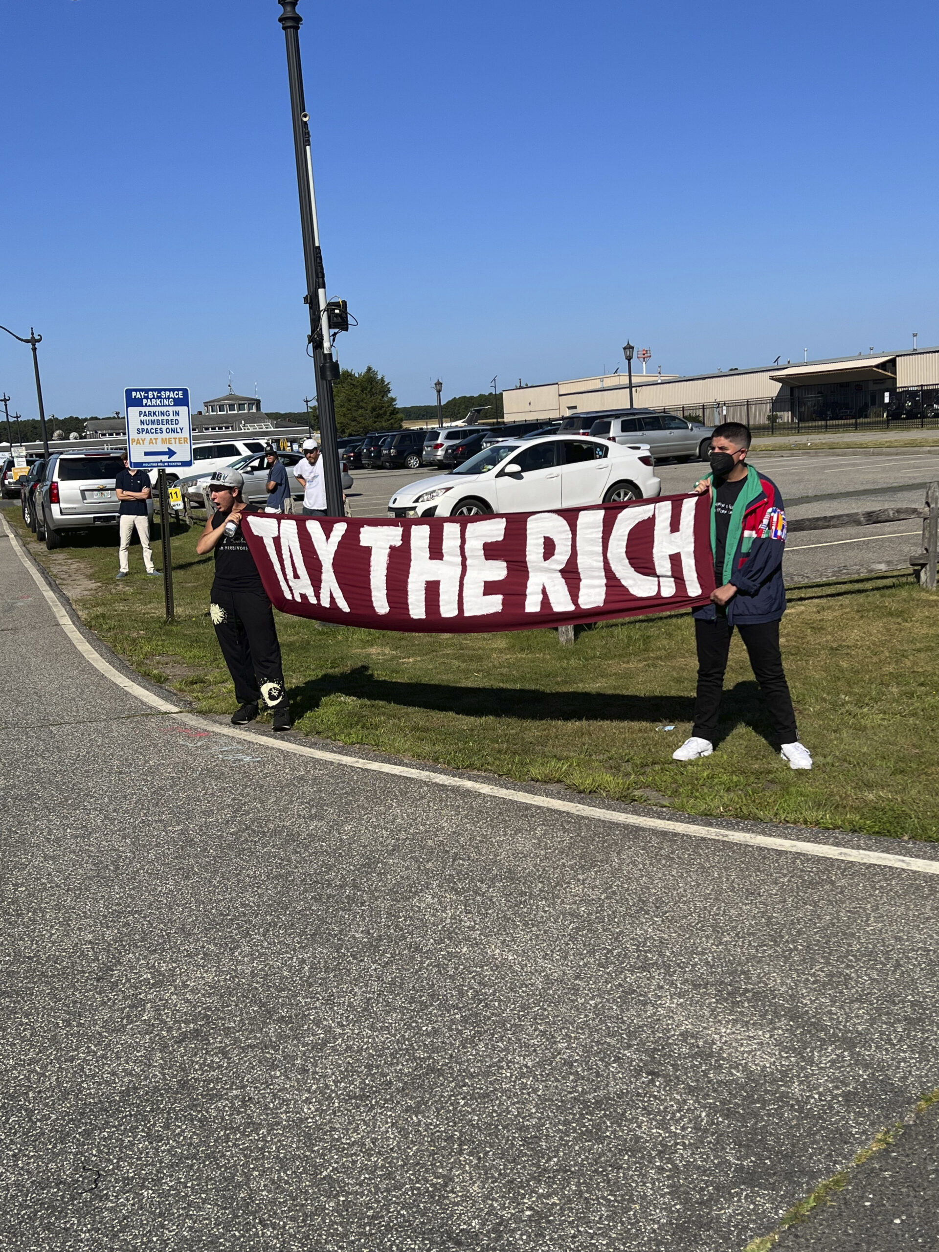 Protesters block the entrance to East Hampton Airport on Monday morning.