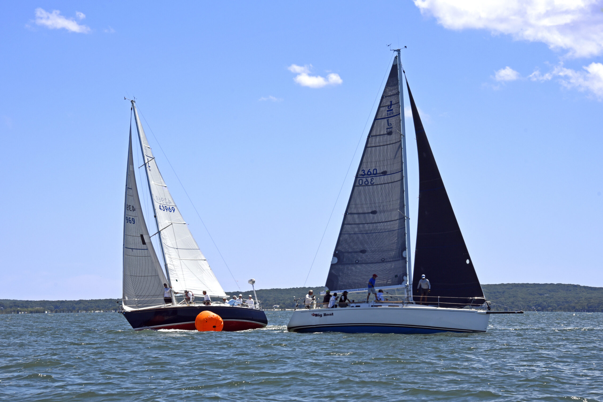 Non-spinnaker winner Philip Walters at
the wheel of the J35 August Sky rounding the weather mark with the winner of the spinnaker division Bud Rogers, Commodore of the Breakwater Yacht Club, on his J-109 Big Boat.    MICHAEL MELLA