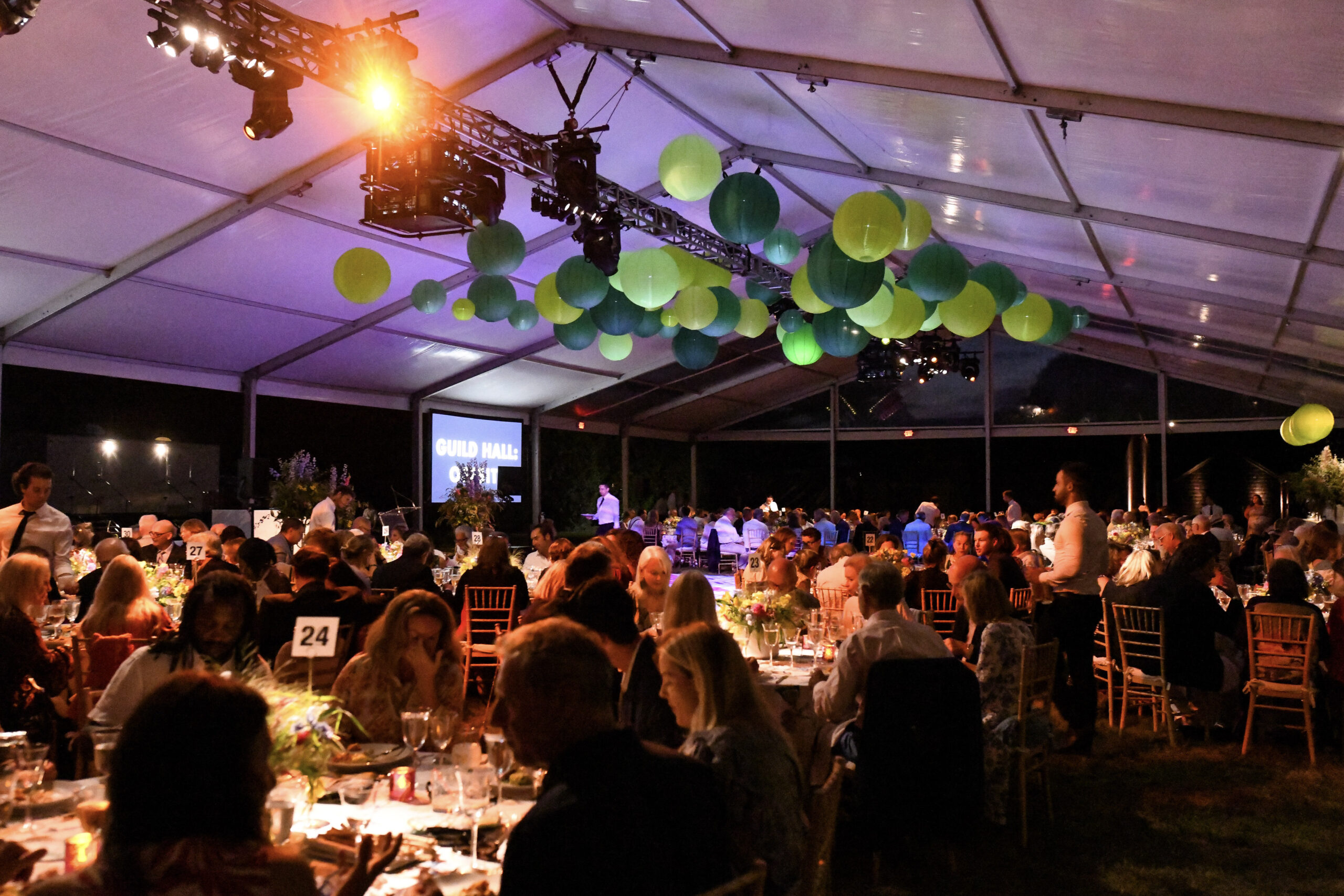 Guild Hall's 2022 Gala honored Kathy Rayner. The event was August 19 at Mulford Farm in East Hampton. Guests dining under the tent. © BFA