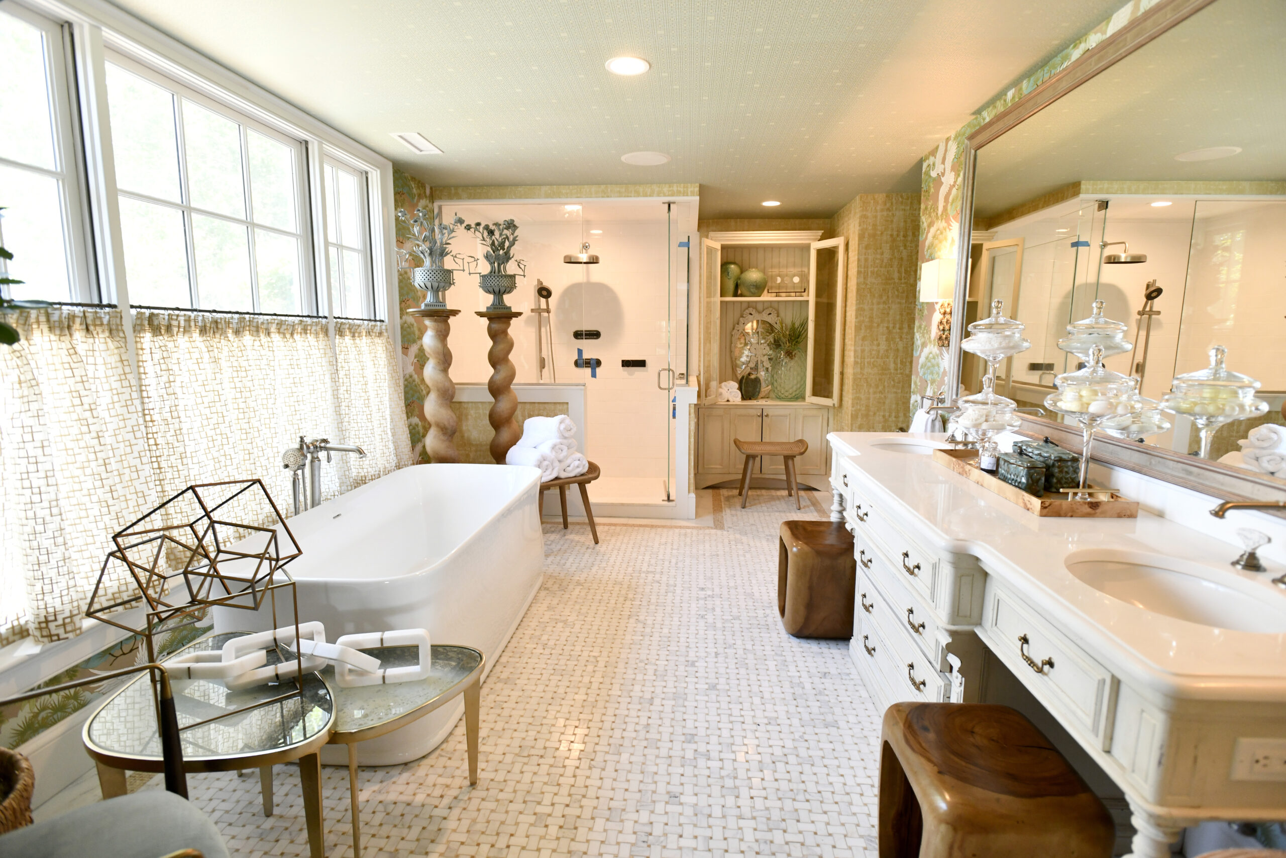 Keith Baltimore’s primary bath at the Hampton Designer Showhouse features an antique chest that was incorporated into a large double vanity. All fixtures and fittings are by Kohler.  DANA SHAW