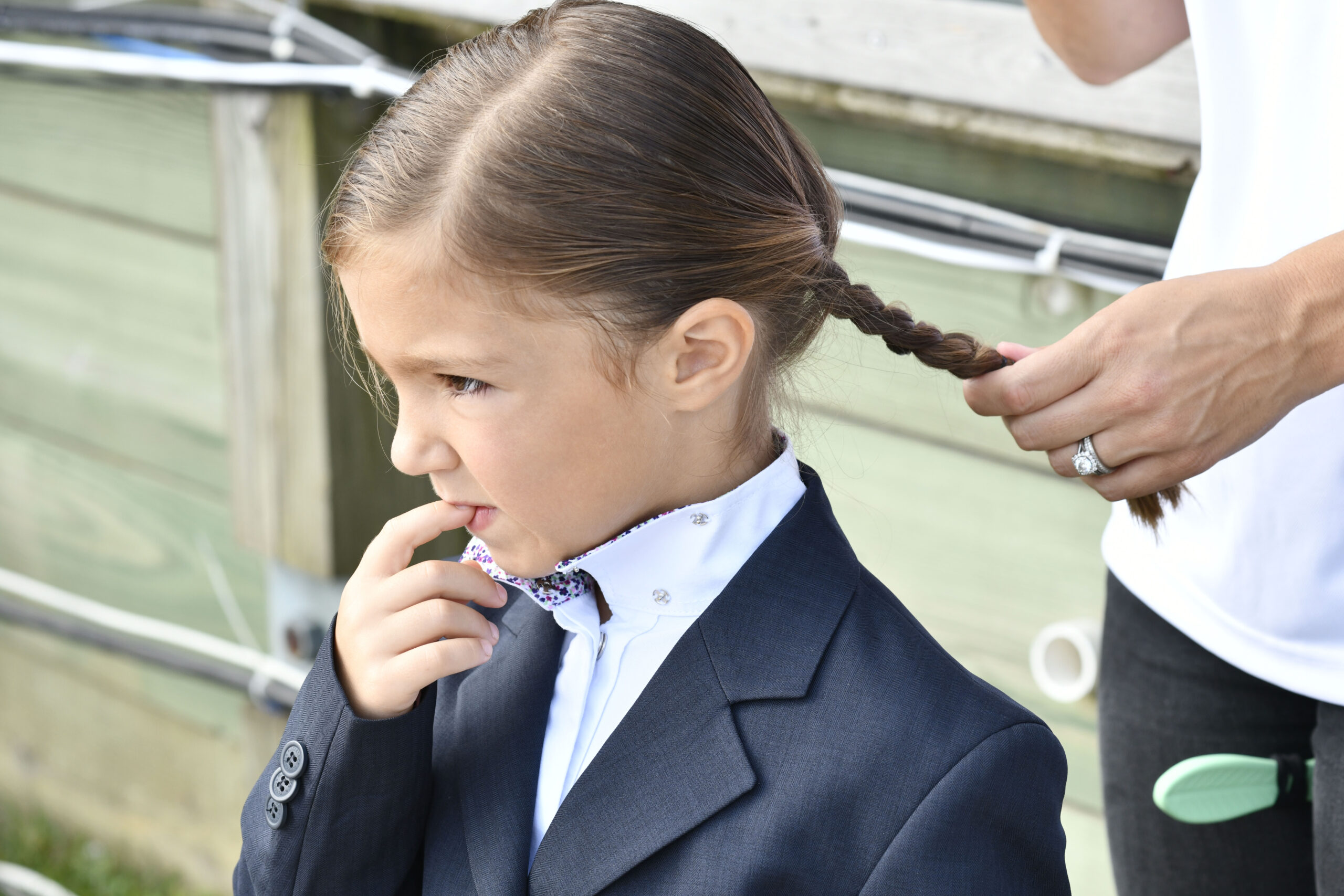 A youngster has their hair braided at the Hampton Classic Horse show on Sunday.  DANA SHAW