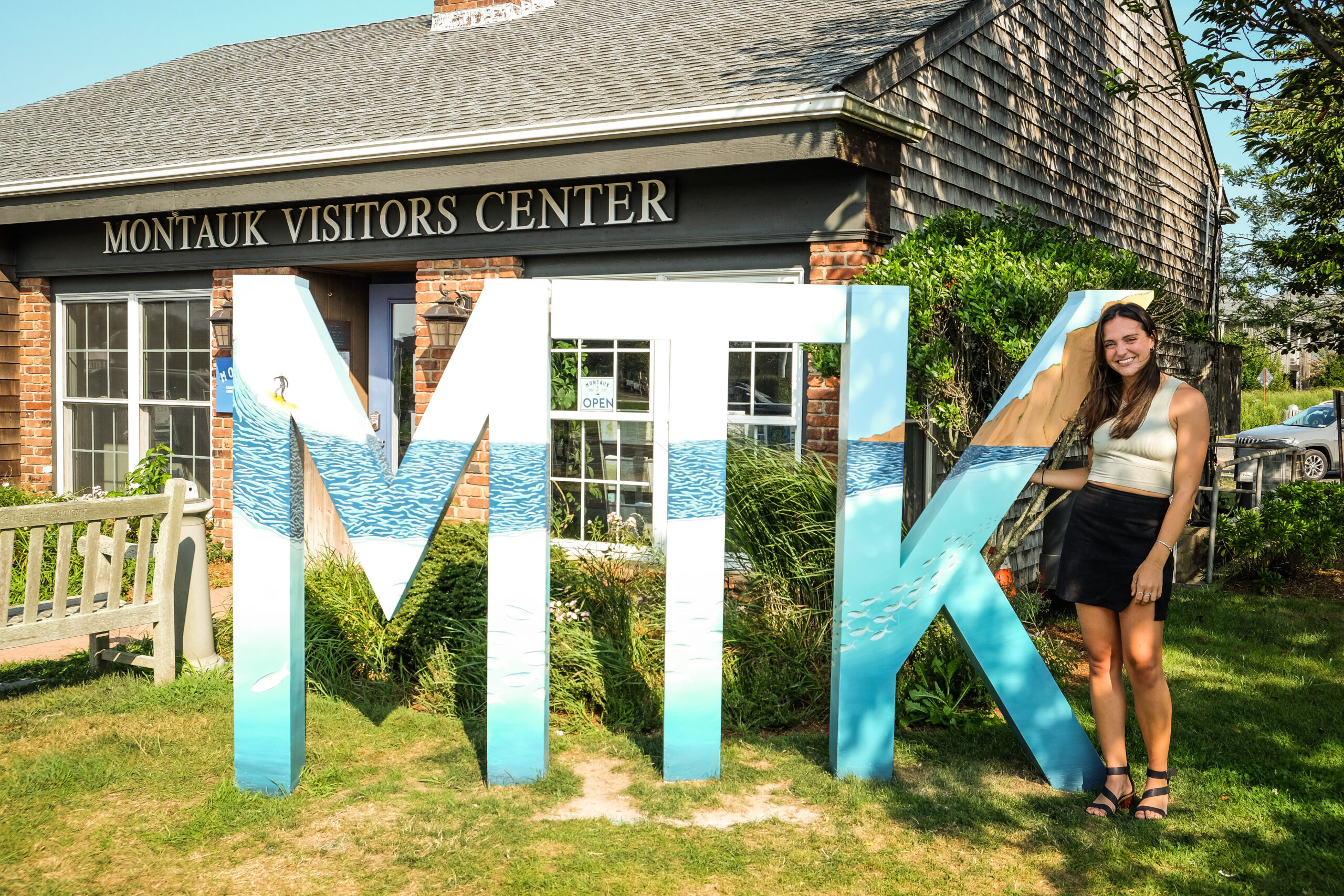 Artist Kylie Ogburn with the painted MTK letters in Montauk. IAN COOKE/COURTESY MONTAUK CHAMBER OF COMMERCE