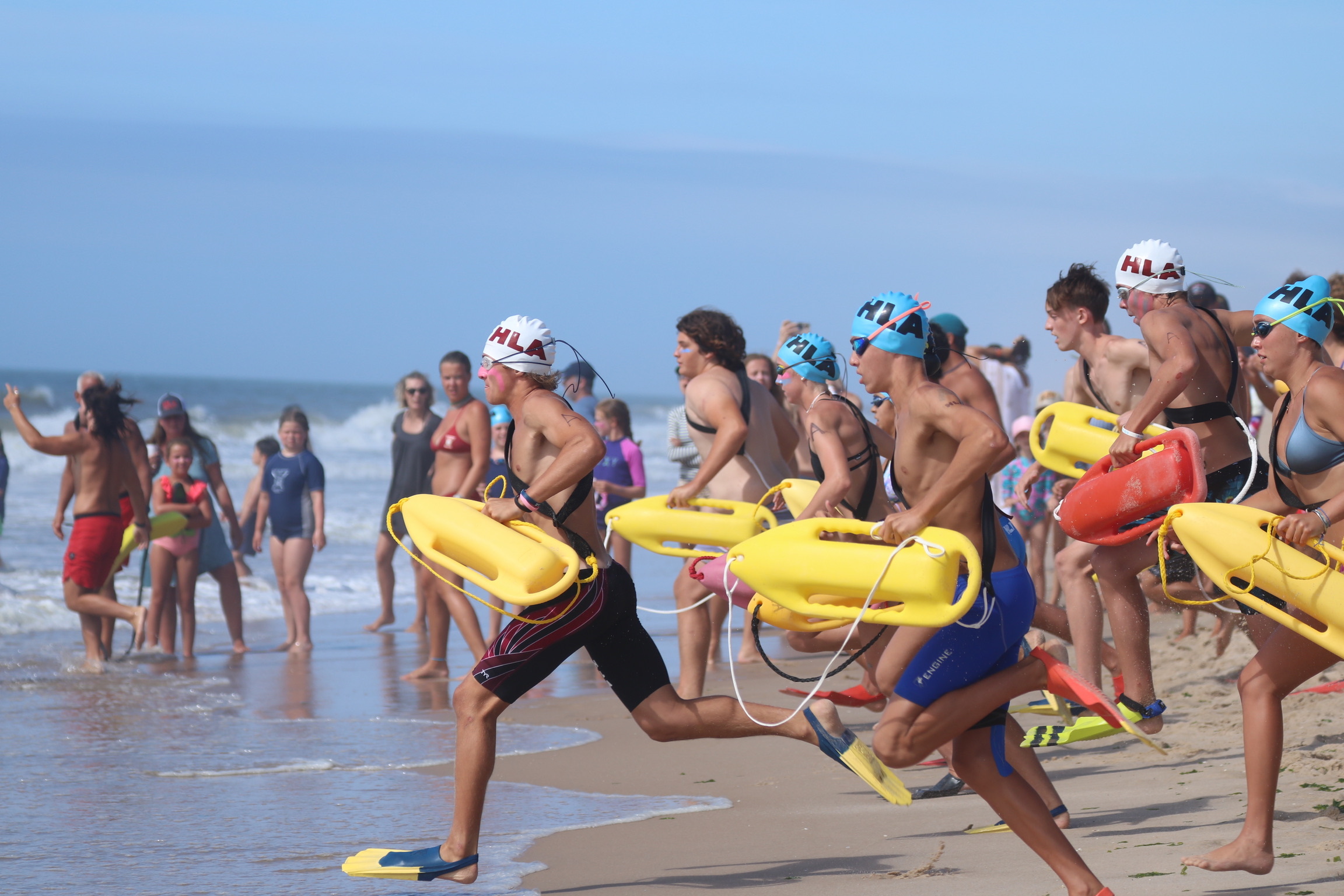 Junior Lifeguards, led by Luke Castillo, at left, enter the water in the torpedo rescue. CINTIA PARSONS