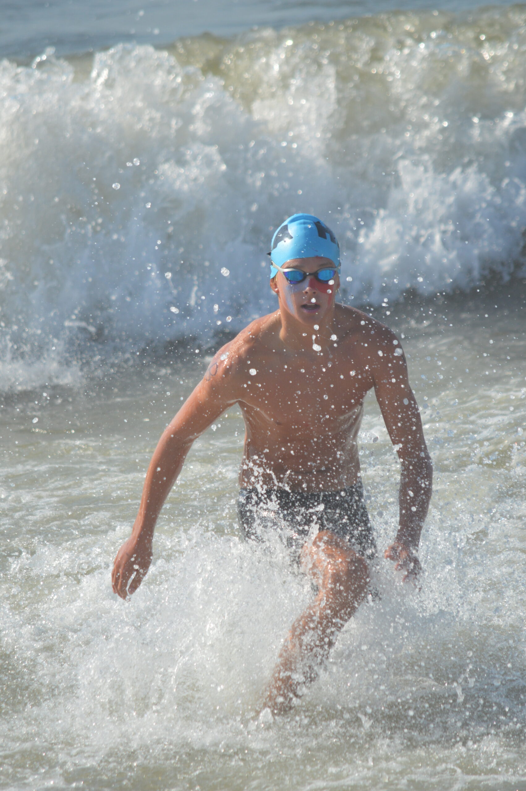 Miles Menu emerges from the distance swim on Saturday. GAVIN MENU