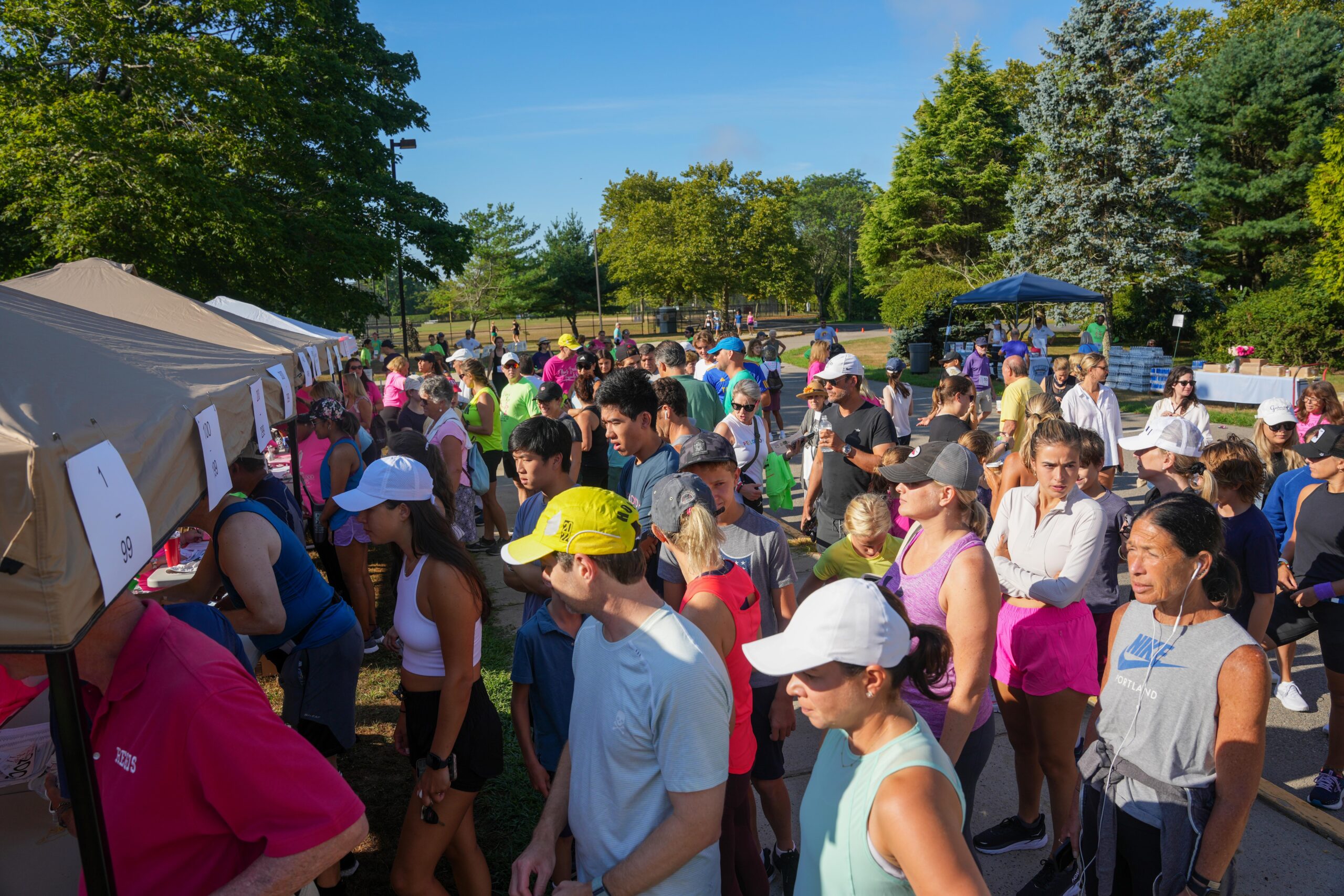 Runners and walkers line up to receive their bibs for Ellen's Run.    RON ESPOSITO