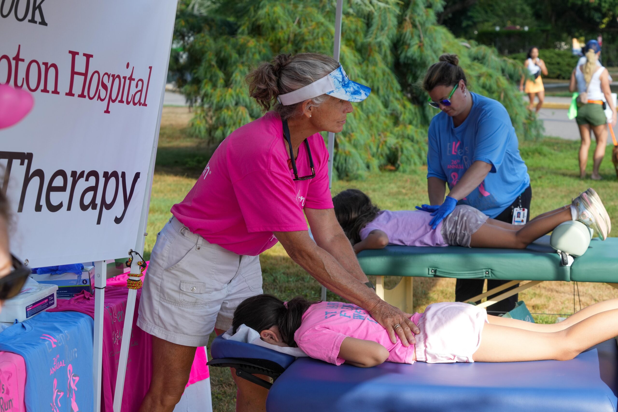 A couple of young runners get massages.    RON ESPOSITO