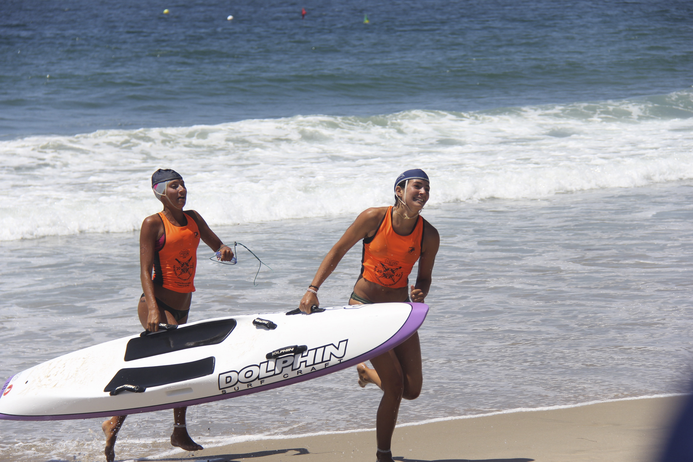 Melina Sarlo and Corrina Castillo emerge from the water during the paddle rescue.     NICOLE CASTILLO