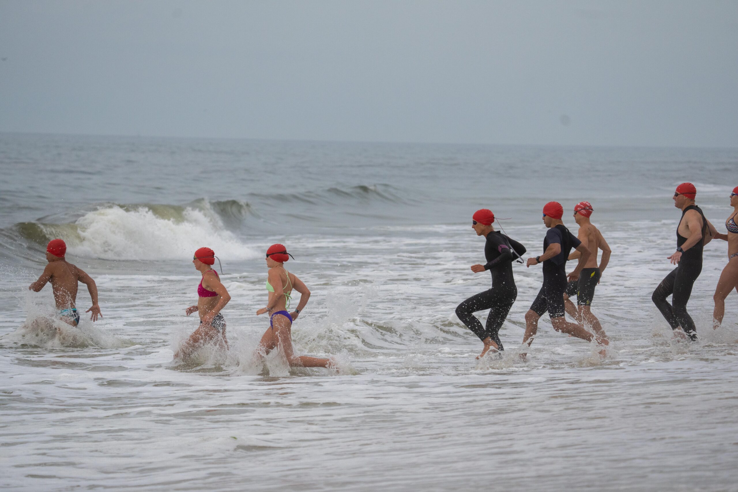 Swimmers jump into the ocean at Coopers Beach on Saturday morning for the first ever S-Mile Swim Challenge hosted by Southampton Village Volunteer Ocean Rescue.    RON ESPOSITO