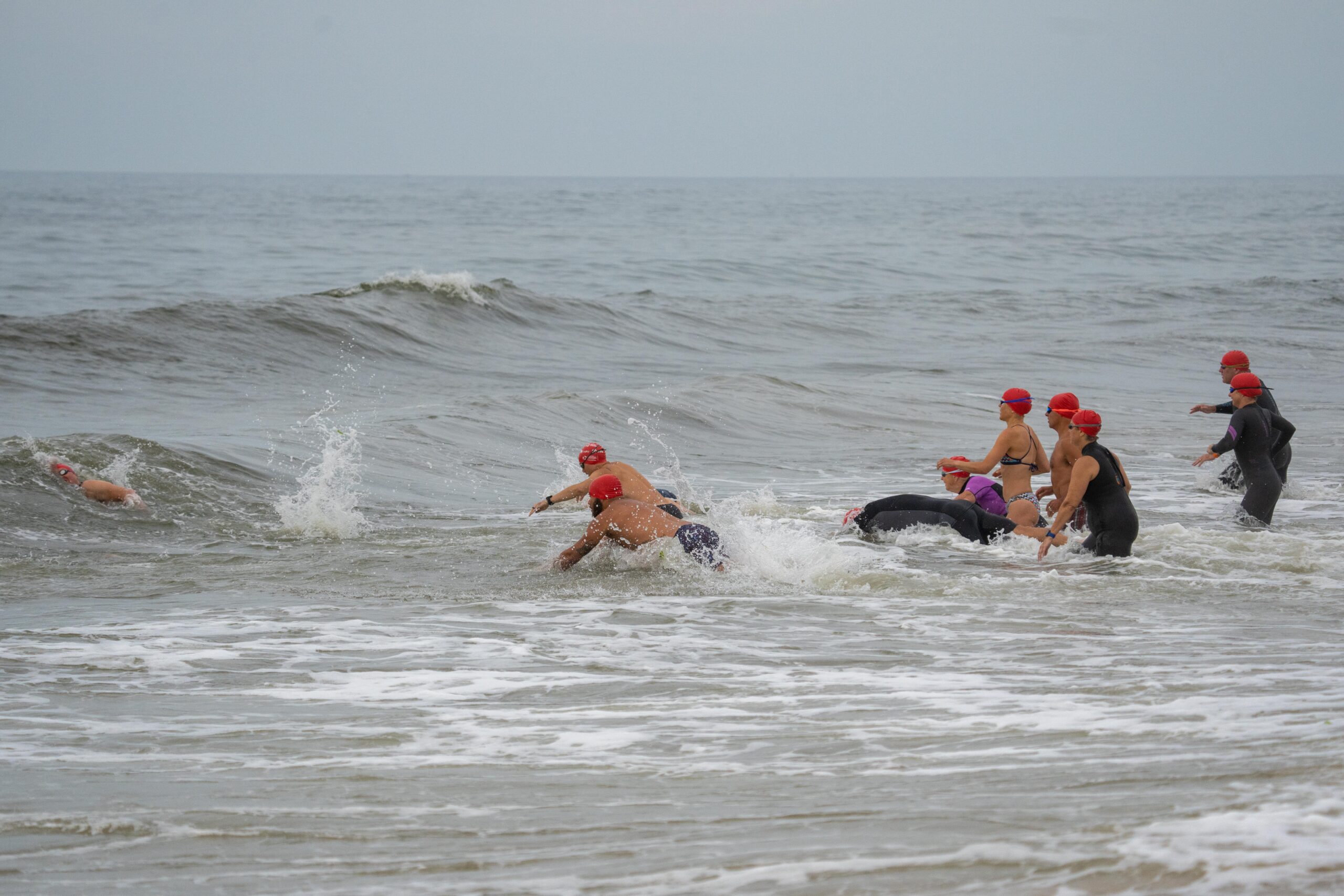 Swimmers jump into the ocean at Coopers Beach on Saturday morning for the first ever S-Mile Swim Challenge hosted by Southampton Village Volunteer Ocean Rescue.    RON ESPOSITO