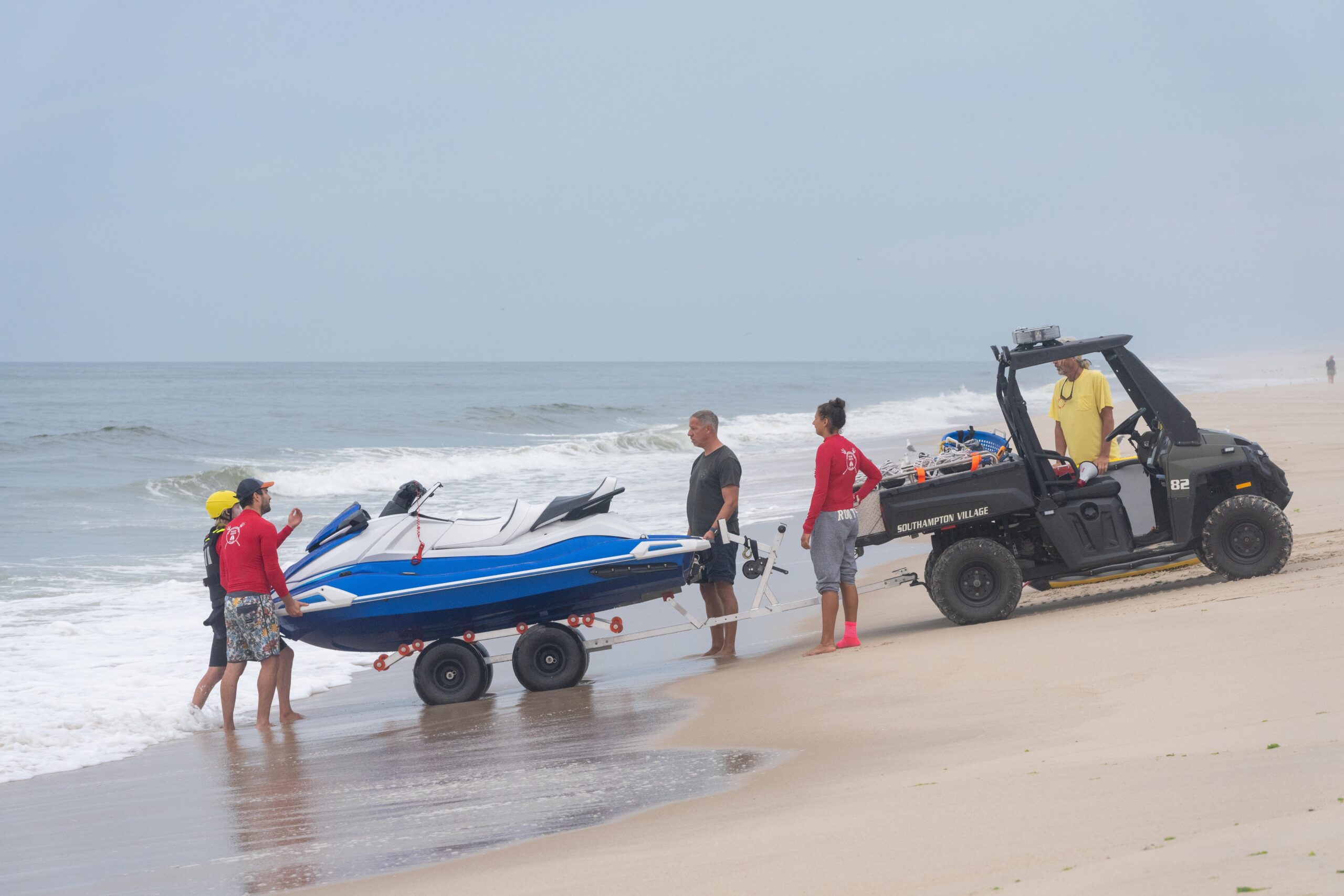 Southampton Village Volunteer Ocean Rescue members get ready to set up the course.   RON ESPOSITO