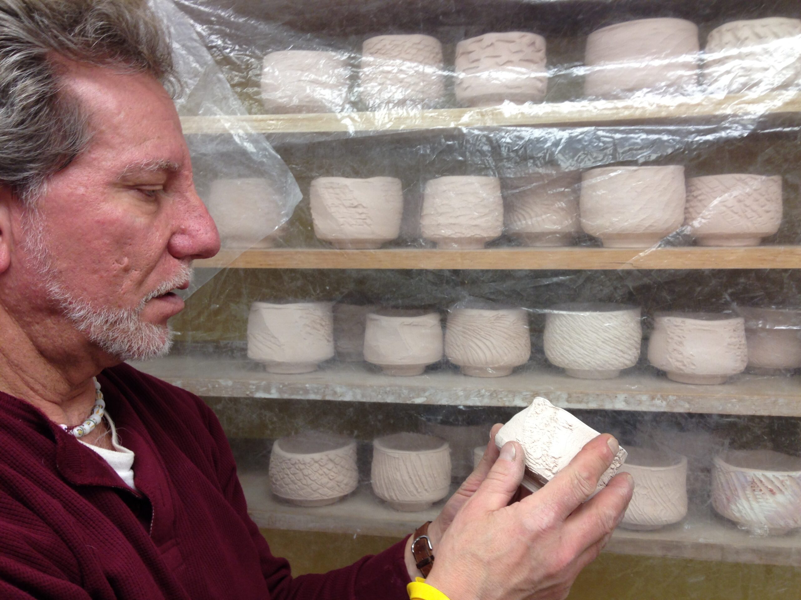 Steven Branfman holds one of the 365 chawan he made in memory of his son, Jared. COURTESY JEN KAPLAN