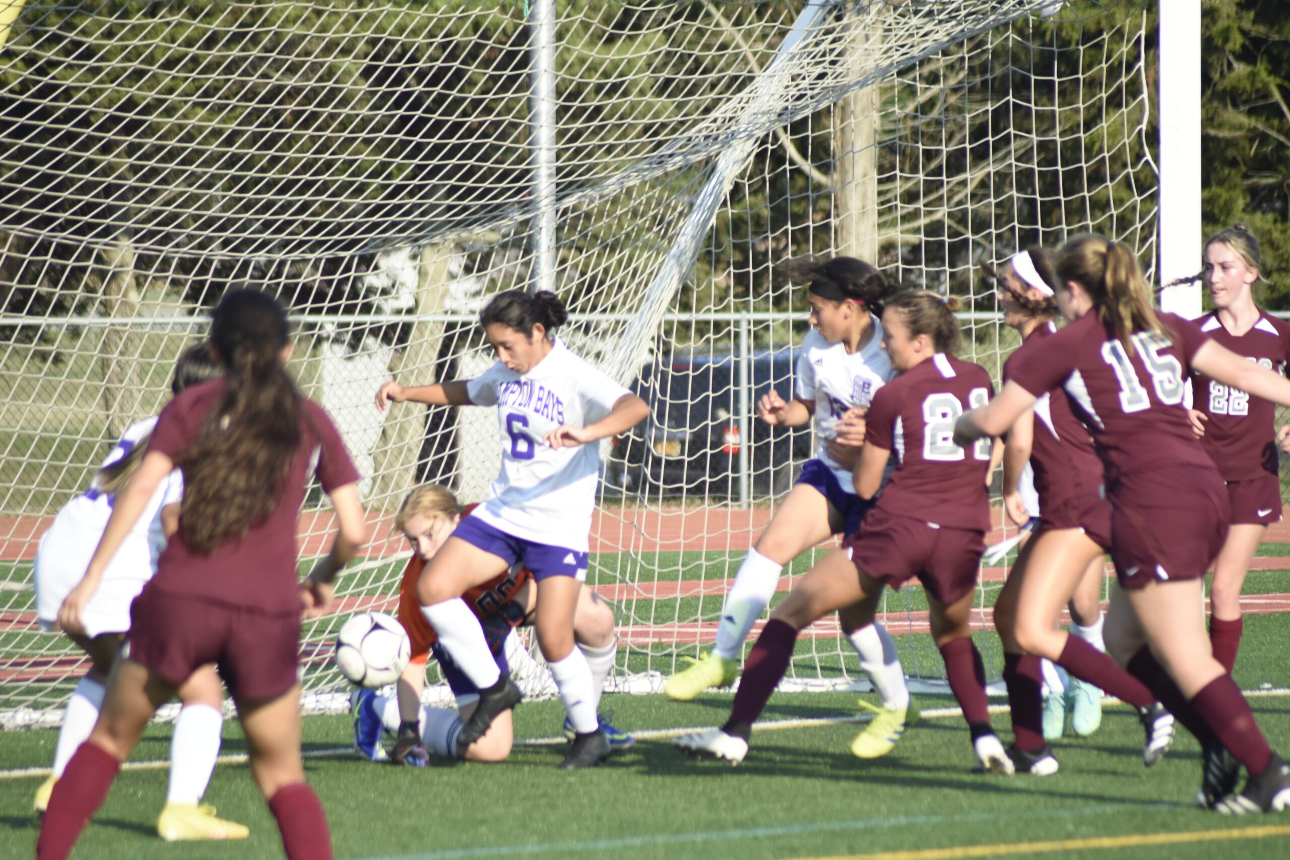 Hampton Bays senior Stephanie Caal boots away a ball in the box.    DREW BUDD