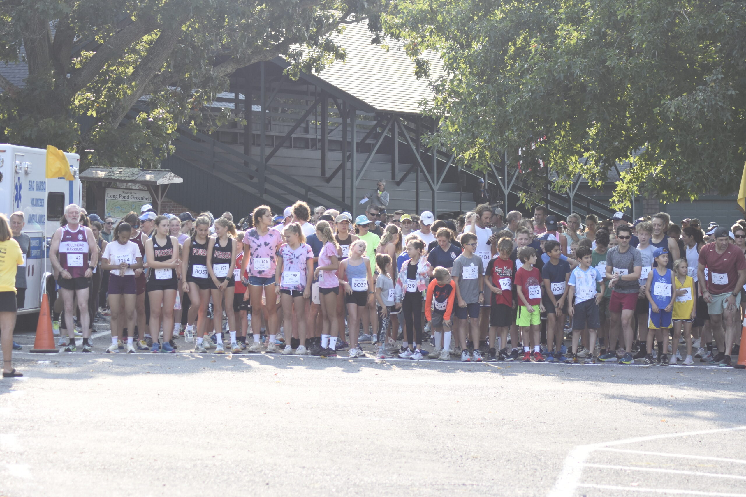 Runners and walkers line up for the start of the second annual Mashashimuet Park Friends and Family 5K on Sunday morning.    DREW BUDD