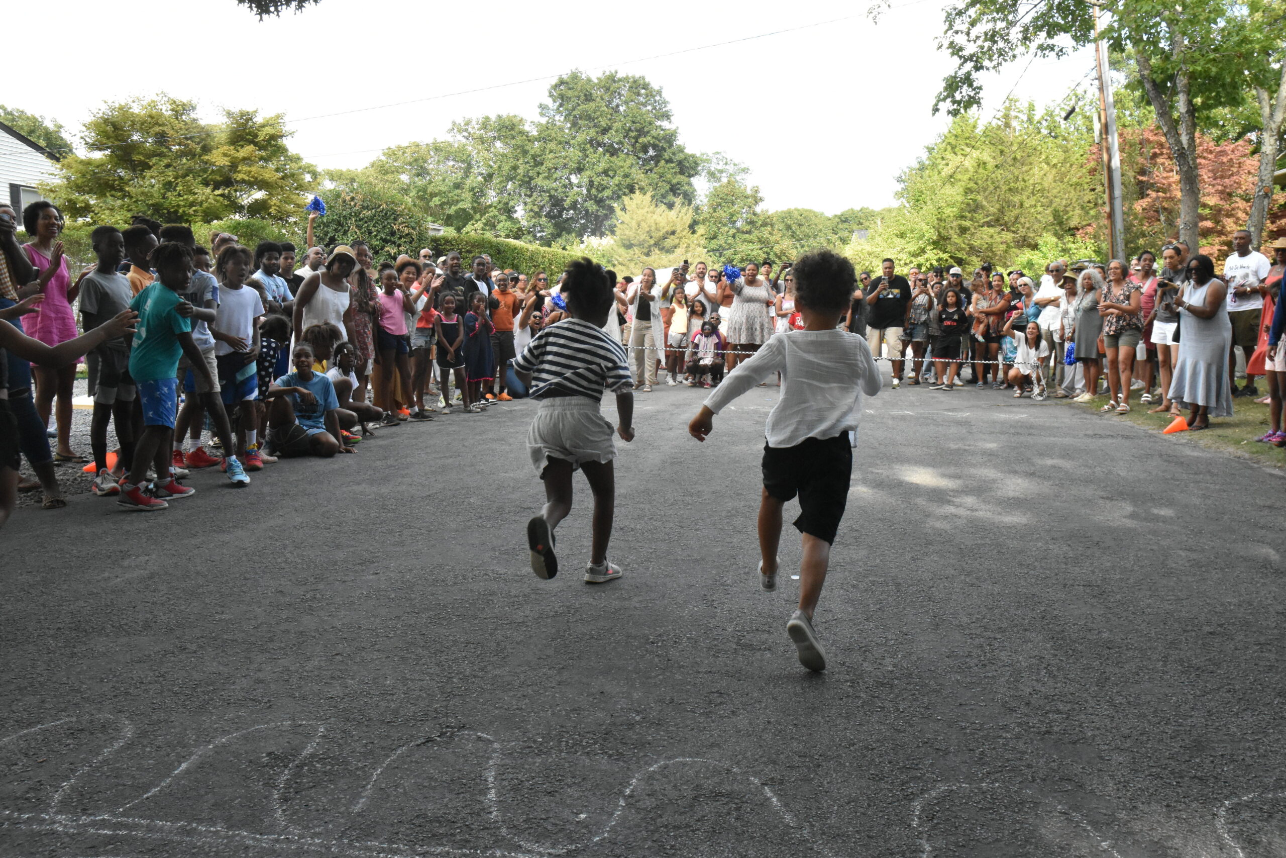 As they do every year, children from 3 to college age, take part in races along Ninevah Place. The distance is extended for each age group. STEPHEN J. KOTZ