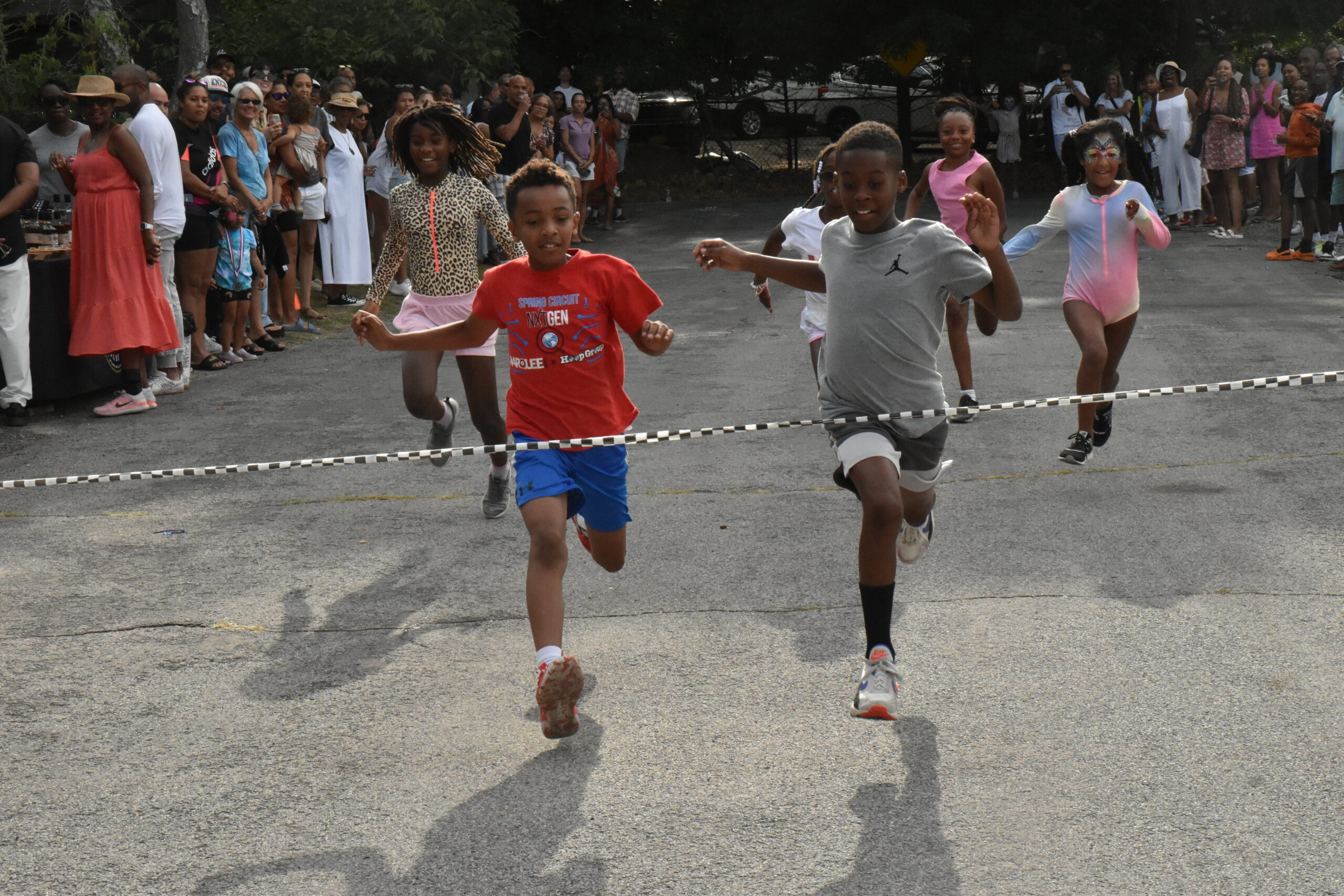 As they do every year, children from 3 to college age, take part in races along Ninevah Place. The distance is extended for each age group. STEPHEN J. KOTZ