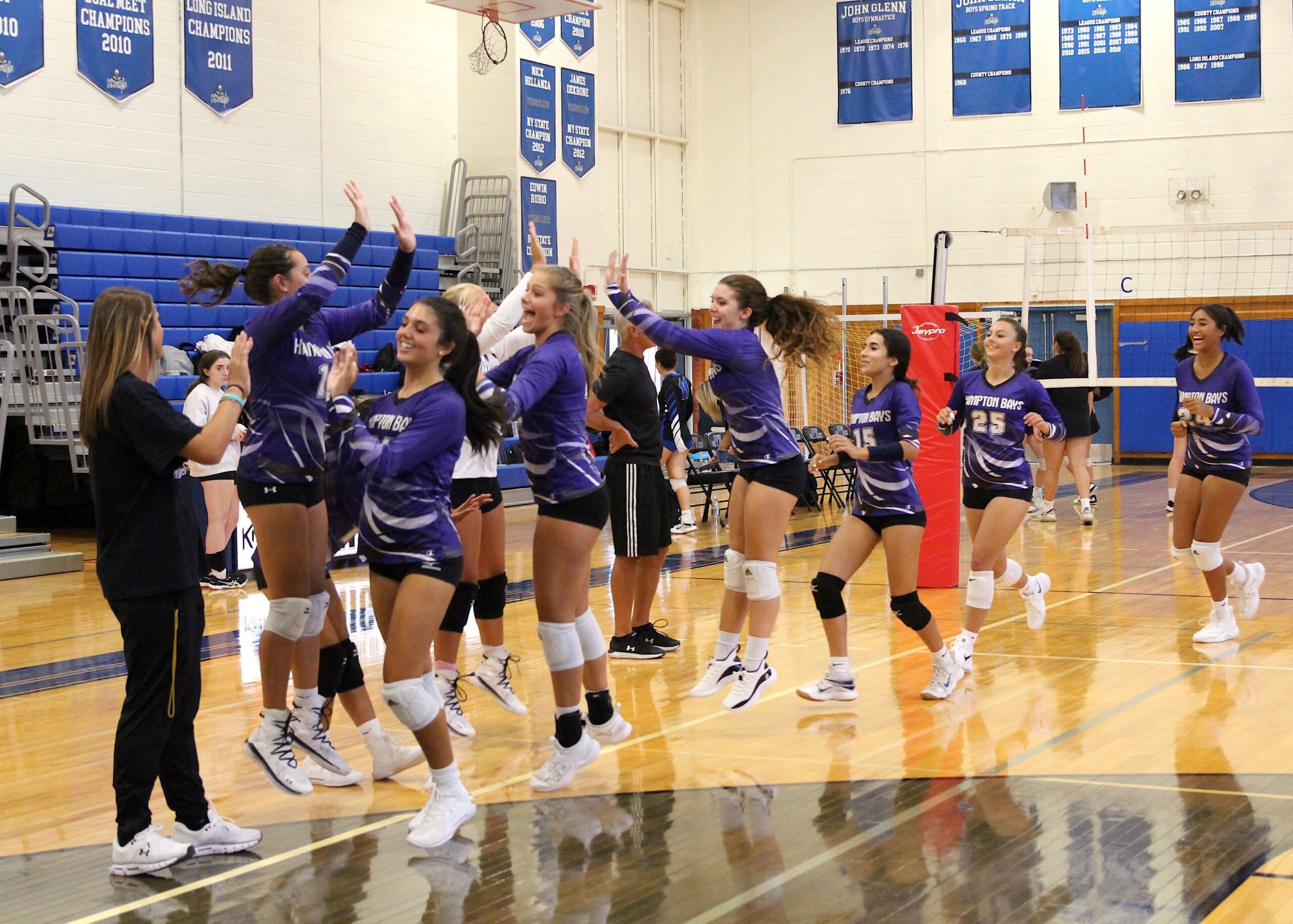 The Hampton Bays' girls volleyball team gets excited for its match against Elwood-John Glenn. MIA CAMEY
