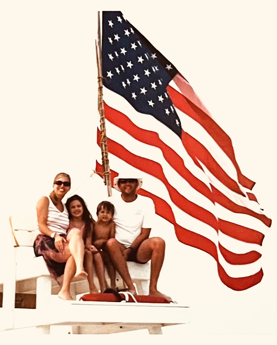 John Neumann on the lifeguard stand with his wife, Danielle, and their children, Grace and Jack.
